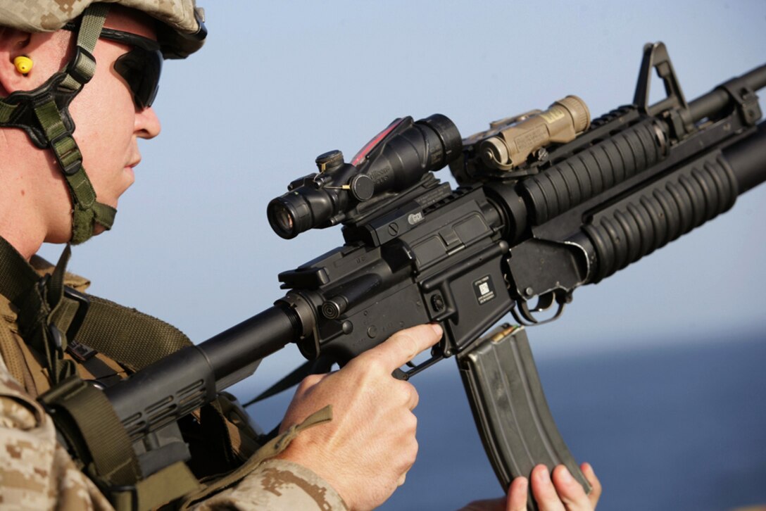 Sgt. Benjamin T. Fisher reloads his rifle while practicing shooting drills aboard USS Bonhomme Richard Nov. 12. Marines with Headquarters and Support Company, Battalion Landing Team 2/4, practiced combat marksmanship on the ship’s flight deck. The San Diego-based unit is embarked aboard amphibious ships conducting maritime security operations in the 5th Fleet area of operations.