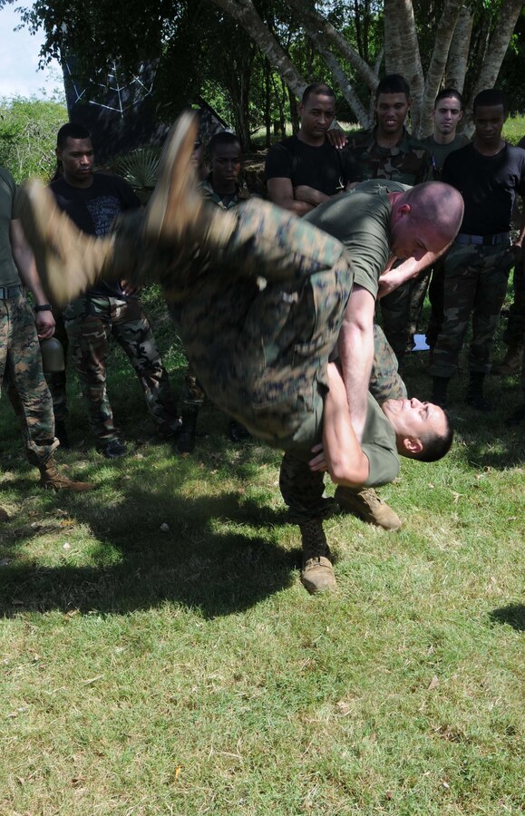 Sgt. Brandon Price, assigned to a Security Cooperation Marine Air-Ground Task Force (SCMAGTF) currently deployed with the multi-purpose amphibious assault ship USS Wasp (LHD 1)  performs a hip throw on Lance Cpl. Marcos Rivera, in front of members of the Dominican Republic military, as part of the Marine Corps. Martial Arts Program during a Theater Security Cooperation event at San Isidro Air Base. Wasp is currently deployed on Southern Partnership Station-Amphib with Destroyer Squadron 40 and embarked SCMAGTF. Southern Partnership Station is part of the Partnership of the Americas Maritime Strategy that focuses on building interoperability and cooperation in the region to meet common challenges. (U.S. Navy Photo by Mass Communication Specialist 3rd Class David Smart/Released)