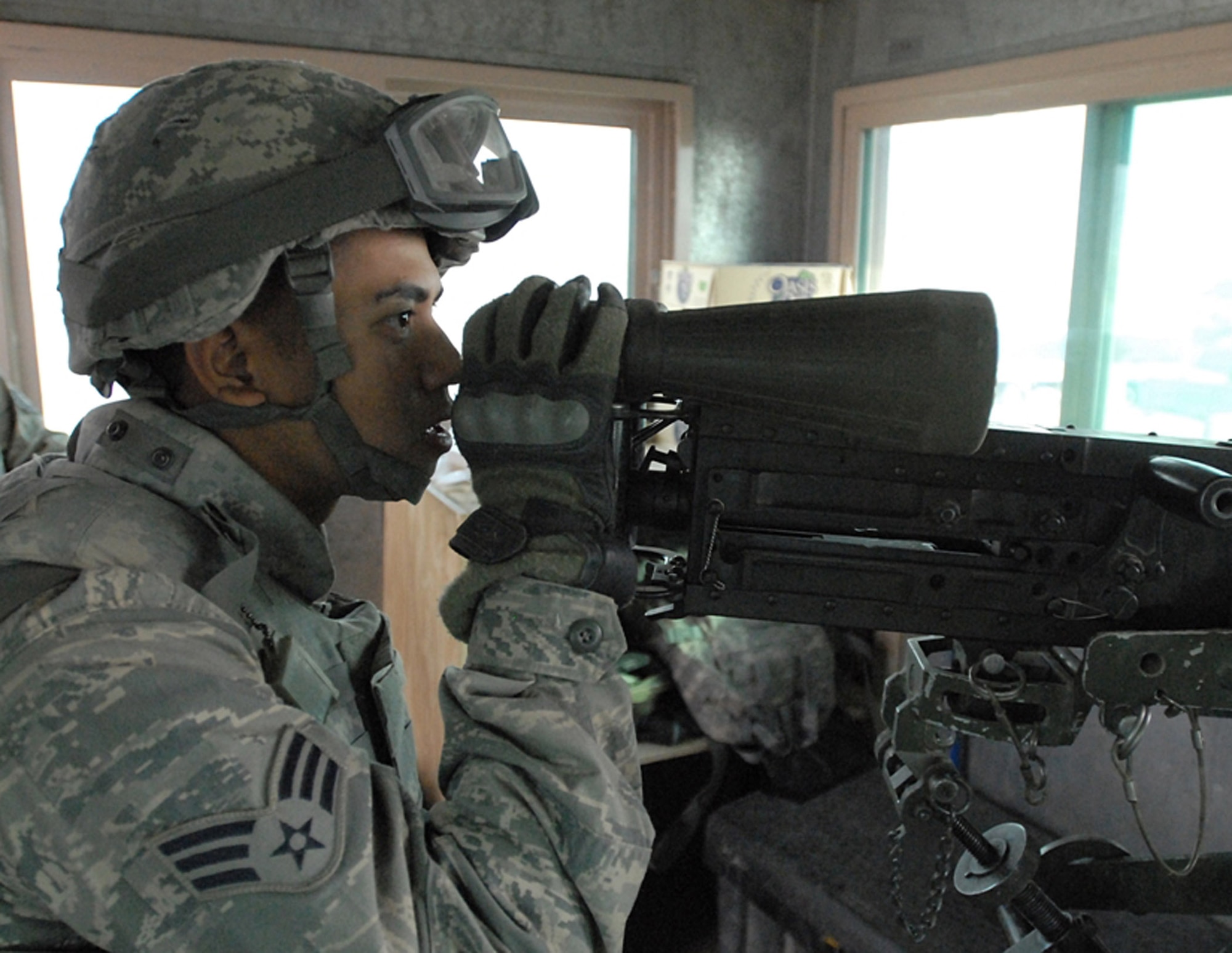 BAGRAM AIRFIELD, Afghanistan -- Senior Airman Mark Joco, a security forces gunner with the 455th Expeditionary Security Forces Squadron, watches the perimeter at an entry control point here. Airman Joco, a Yokosuka, Japan, native is deployed from the 99th Security Forces Squadron based at Nellis Air Force Base, Nev. (U.S. Army photo/Spc. William E. Henry)
