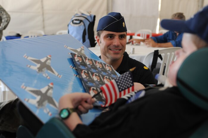 NELLIS AIR FORCE BASE, Nev.--  Matt Dembik Jr., a nine year-old diagnosed with spinal muscular atrophy is greeted by Maj. Rick Goodman, U.S. Air Force Aerial Demonstration Team Thunderbirds right wing pilot during the rehearsal show for the Nellis Open House Nov. 13. Matt was invited to attend the rehearsal day through the Make a Wish Foundation. The Make a Wish Foundation is a non-profit organization aimed toward granting wishes of children with life-threatening conditions. (U.S. Air Force photo by Tech. Sgt. Michael R. Holzworth)