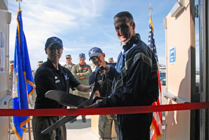 CREECH AFB, Nev. -- Colonel Pete Gersten (right), 432d Wing and 432d Air Expeditionary Wing commander, Master Sergeant Ronnell Ramos (center), 99th Force Support Squadron OL-A Sustainment Superintendent, and Tech. Sergeant Martha Johnson, 99 FSS OL-A Creech Fitness Center Manager, cut the ribbon during the new Creech Fitness Center here Nov. 10. (U.S. Air Force photo/Staff Sgt. Alice Moore)