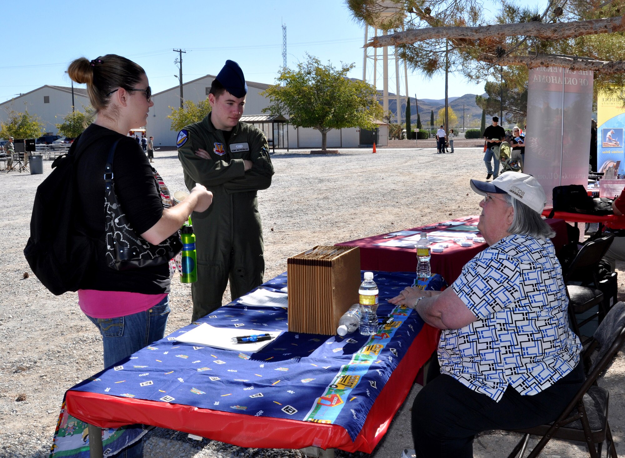 CREECH AIR FORCE BASE, Nev.-- Airman 1st Class Kenneth Matheson, 42nd Attack Squadron, MQ-9 Sensor Operator, and his wife Amber Matheson, speak with a representative from the education center about the different options and opportunities available to dependents during the Creech AFB Family Day Nov. 2. (U.S. Air Force Photo / Airman 1st Class Stephanie Rubi)