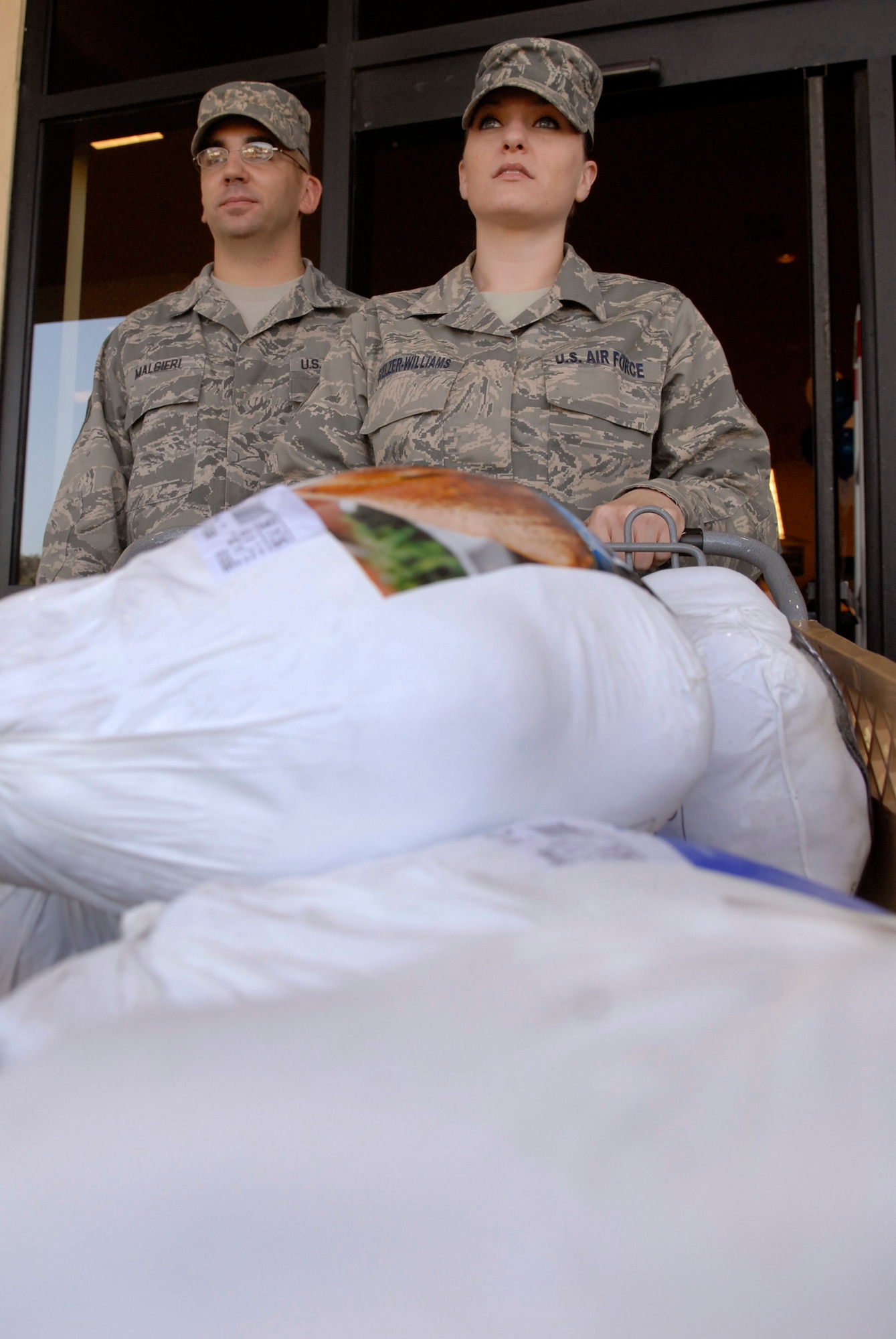 LOMPOC, Calif. – Senior Airman Laura Stelzer-Williams, a 532nd Training Squadron information manager, and Staff Sgt. Scott Malgieri, a 532nd TRS instructor, cart a load of turkeys out of a Vons grocery store here Friday, Nov. 13, 2009. Lydell Sargeant, a native of Lompoc and professional football player, donated approximately 15 Turkeys to Airmen who will not get the chance to go home for the holidays. (U.S. Air Force photo/Senior Airman Andrew Satran)