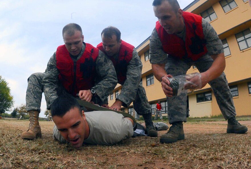 DYESS AIR FORCE BASE, Texas -- 7th Medical Group manpower personnel detain a patient from causing further harm to himself or staff during a mass casualty training exercise here Nov. 13. 7 MDG staff were given two phases of unexpected scenarios for this exercise.  (U.S. Air Force photo by Senior Airman Domonique Washington)