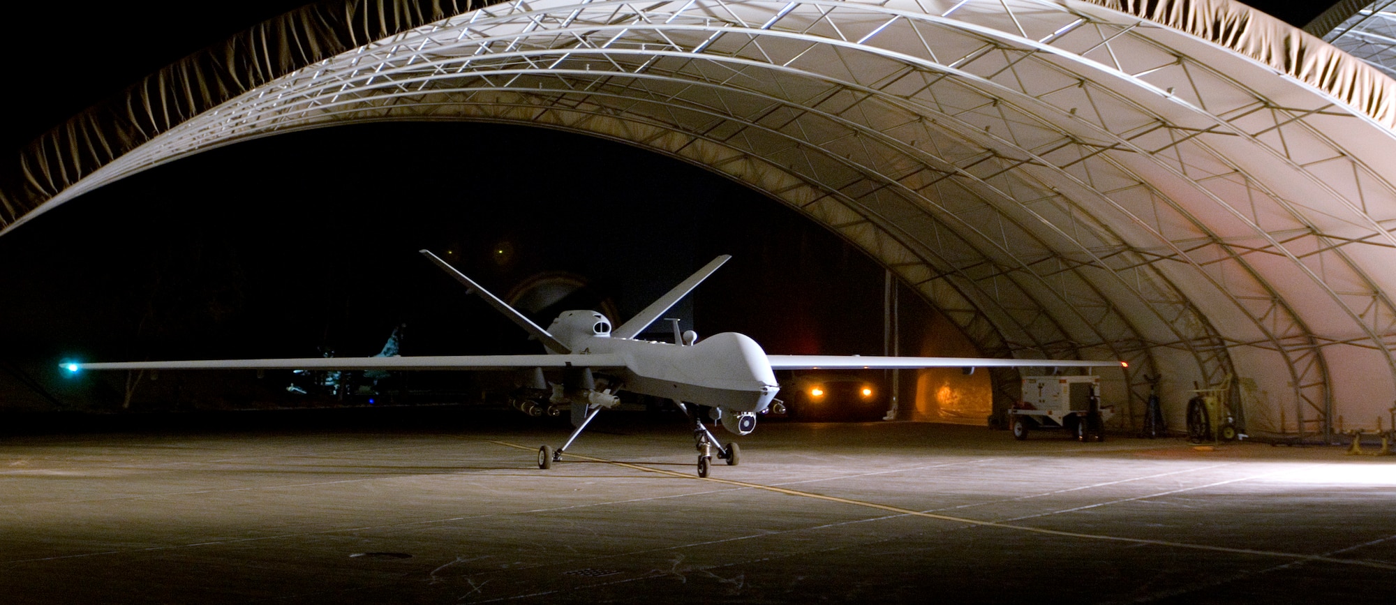 An MQ-9 Reaper remotely piloted aircraft prepares to taxi out of a hangar at Joint Base Balad in Iraq. (U.S. Air Force photo/Tech. Sgt. Erik Gudmundson)