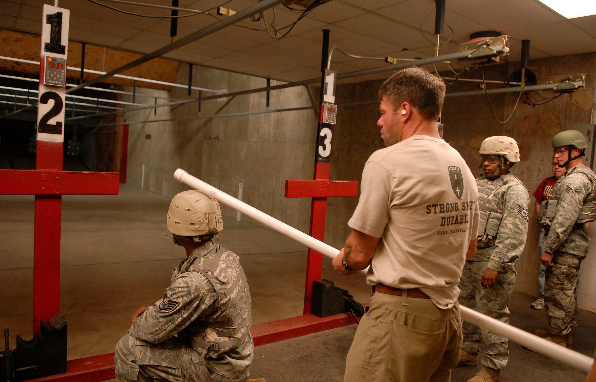 Rob Shaul, strength and conditioning coach, demonstrates the proper way to hit an individual's head when they miss their target at the Combat Arms Training and Maintenance building, Nov. 3. (U.S. Air Force photo by Airman 1st Class Ronifel Yasay)