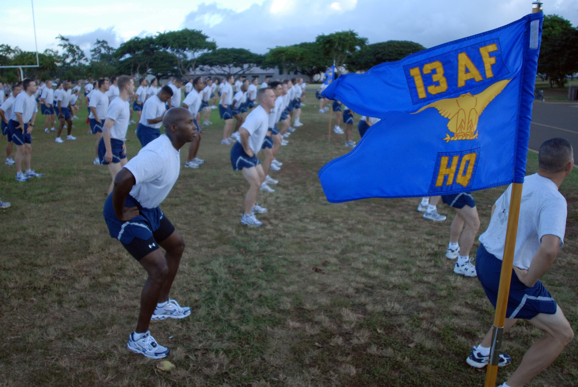 Members of 13th Air Force warm up before a warrior run during Jungle Day Nov. 13 at Hickam Air Force Base, Hawaii. The Jungle Day tradition originated when the organization was assigned to Andersen Air Force Base, Guam, and gives 13th Air Force members a chance to have fun and give back to the local community. (U.S. Air Force photo/Senior Airman Gustavo Gonzalez)