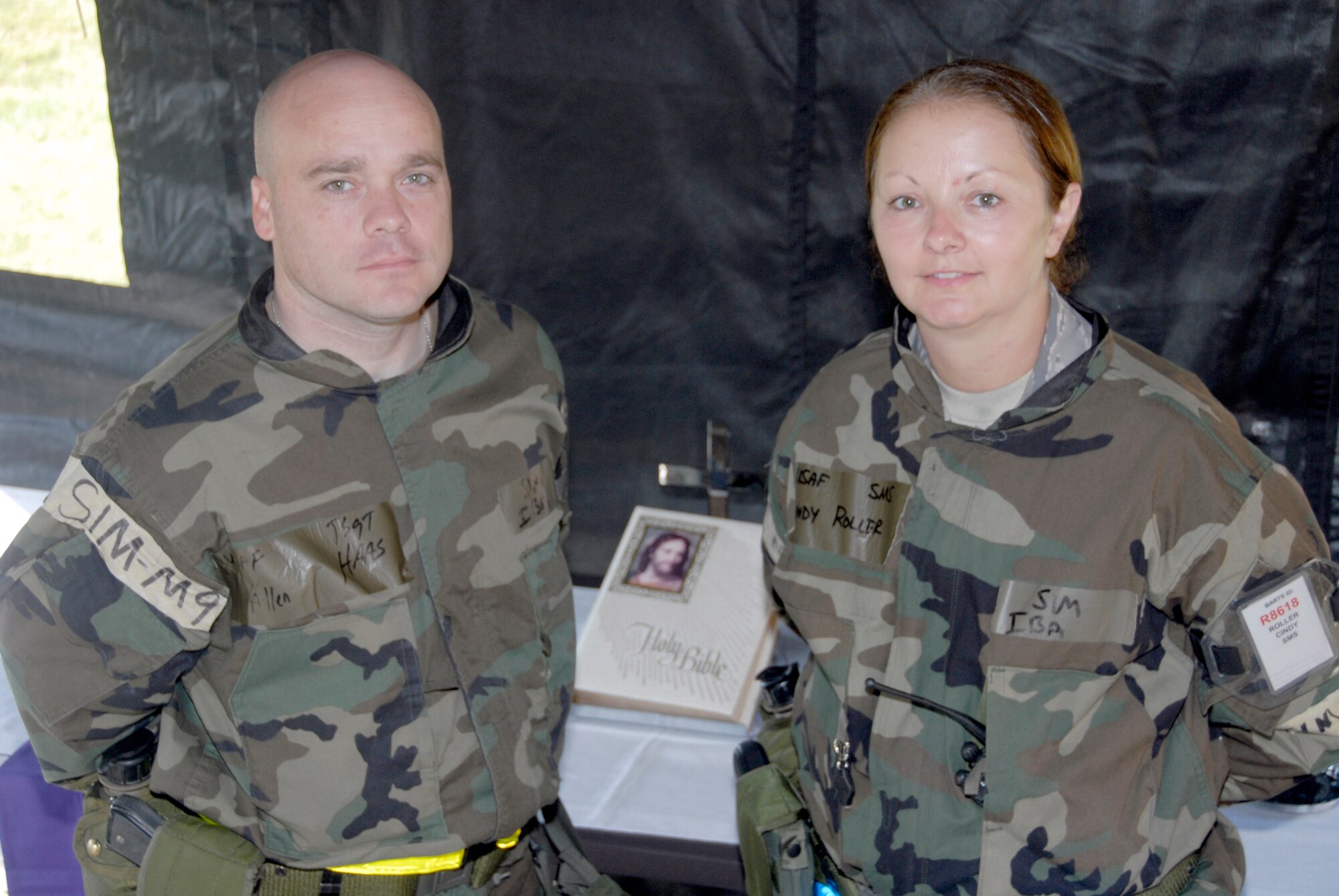Tech. Sgt. Allen Haas and Senior Master Sgt. Cindy Roller insde the chaplain's tent during the wing's operational readiness exercise Sept. 18.  Both are chaplains' assistants assigned to the 442nd Fighter Wing's Chaplaincy.  While part of their mission during wartime is to provide armed protection for the chaplain, they both agree that sensitivity and compassion are part of the job.  The wing has three chaplains' assistants -- the other being Staff Sgt. Randy Chambers, as well as two commissioned chaplains -- Maj. James Buckman and Capt. Ben Hayden. (U.S. Air Force photo/Staff Sgt. Kent Kagarise)
