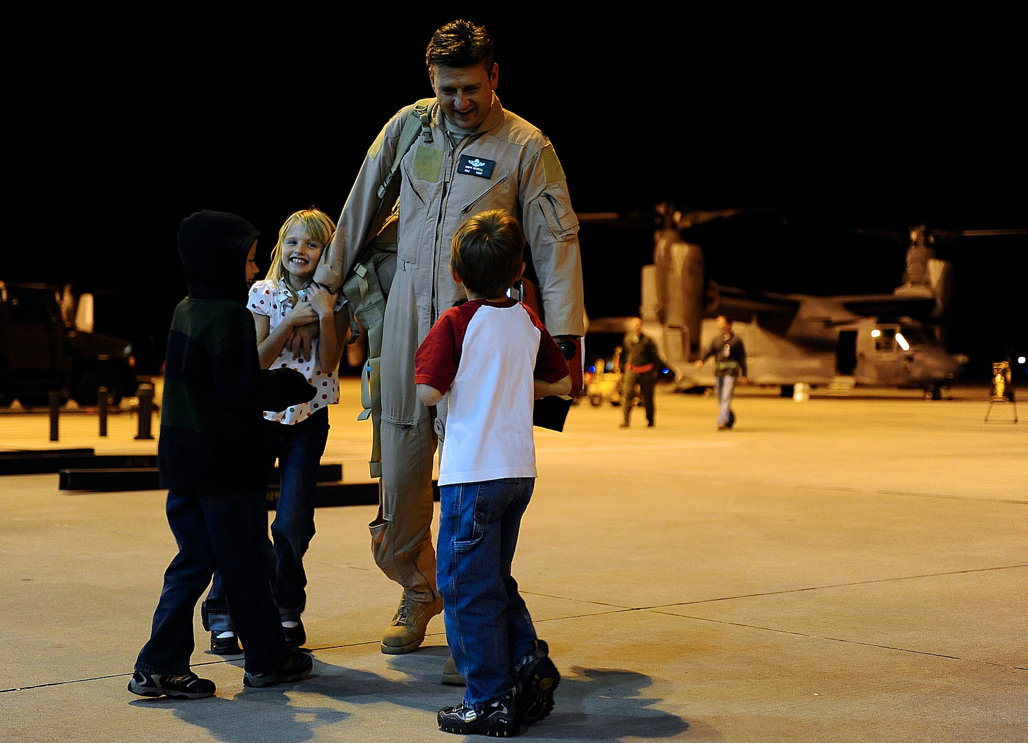 Maj. Mark Newell, 8th Special Operations Squadron, greets his family Nov. 12, 2009, Hurlburt Field, Fla. Major Newell returned from a three-month deployment to Southwest Asia. (U.S. Air Force photo by Senior Airman Julianne Showalter/Released)