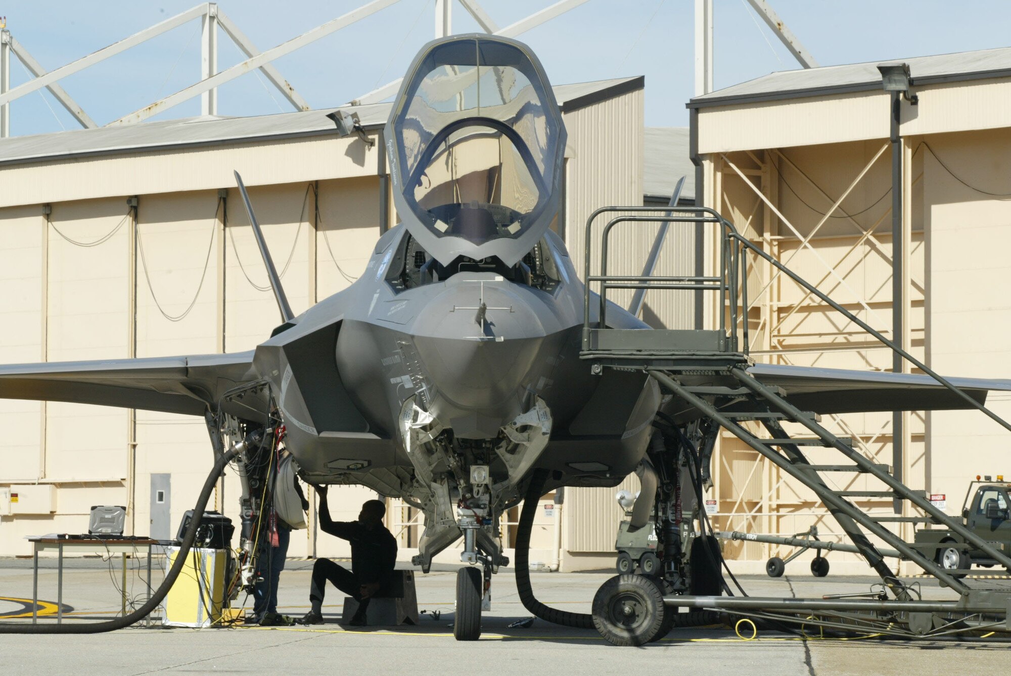 A maintainer works on an F-35 Joint Strike that landed at Dobbins Air Reserve Base, Ga. Nov. 13 during a cross-country flight. The F-35 is a stealthy, single-engine, supersonic multi-role fighter that will replace a variety of aging fighter and strike aircraft for the Air Force, Navy, Marine Corps and allied defense forces. The F-35 is built by the Lockheed Martin plant in Fort Worth, Texas. (U.S. Air Force photo/Don Peek)