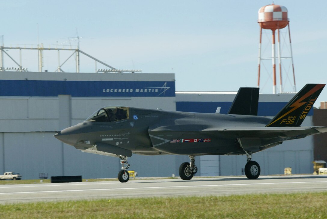 An F-35 Joint Strike Fighter taxis past the Lockheed Martin Marietta Plant, which shares a runway with Dobbins Air Reserve Base, Ga. Nov. 13 during a cross-country flight. The F-35 is a stealthy, single-engine, supersonic multi-role fighter that will replace a variety of aging fighter and strike aircraft for the Air Force, Navy, Marine Corps and allied defense forces. The F-35 is built by the Lockheed Martin plant in Fort Worth, Texas. (U.S. Air Force photo/Don Peek)