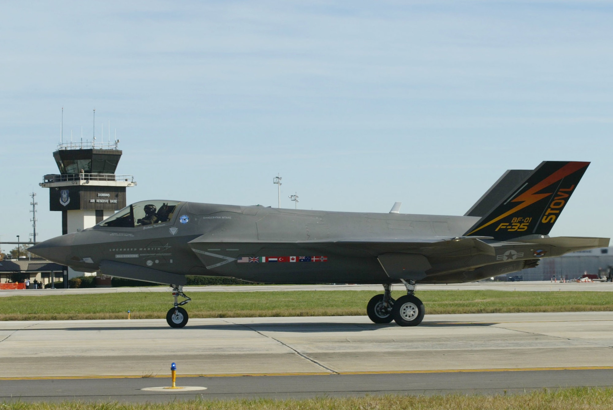 An F-35 Joint Strike Fighter taxis past the control tower at Dobbins Air Reserve Base, Ga. Nov. 13 during a cross-country flight. The F-35 is a stealthy, single-engine, supersonic multi-role fighter that will replace a variety of aging fighter and strike aircraft for the Air Force, Navy, Marine Corps and allied defense forces. (U.S. Air Force photo/Don Peek)