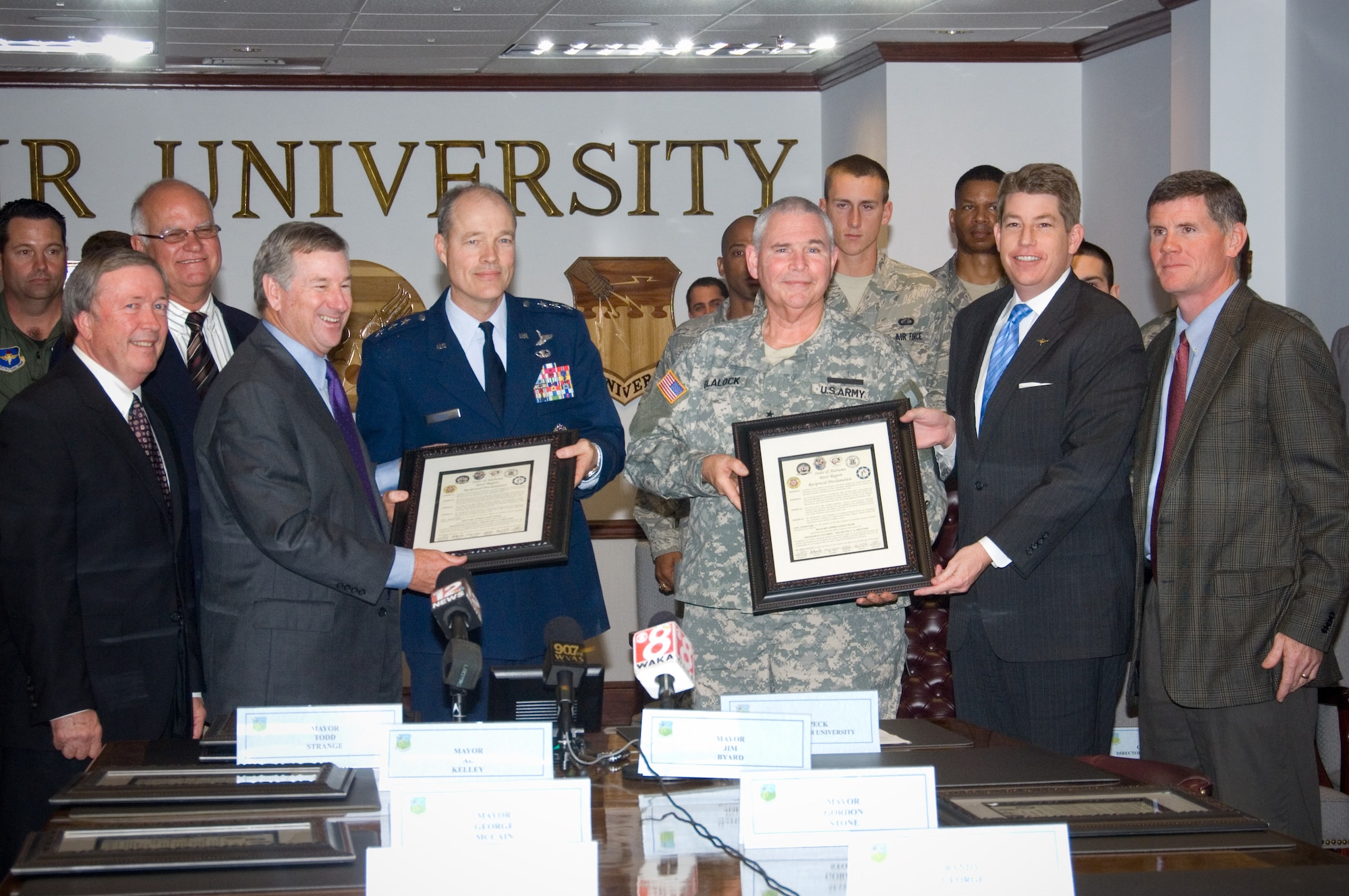 Five mayors from the River Region paid a special visit to Maxwell to present a joint proclamation designating Nov. 8-14 as Military Appreciation Week. Receiving the proclamation were commanders from the surrounding area that included Air University, 42nd Air Base Wing, the Air Force Reserve and the Alabama National Guard. “To better inform the River Region citizens about the importance of our military neighbors,” the proclamation also authorized businesses to display banners “recognizing the impact our military and their families have on our communities as we recognize their sacrifice, support and dedication.” Shown from left are Tallessee Mayor George McCain, Millbrook Mayor Al Kelley, Montgomery Mayor Todd Strange, Air University Commander Lt. Gen. Allen G. Peck, Alabama National Guard Adjutant General Maj. Gen. A.C. Blalock, Prattville Mayor Jim Byard Jr., and Pike Road Mayor Gordon Stone. Not pictured, but also signing the proclamation, is Wetumpka Mayor Jerry Willis. (U.S. Air Force photo/Melanie Rodgers Cox)


