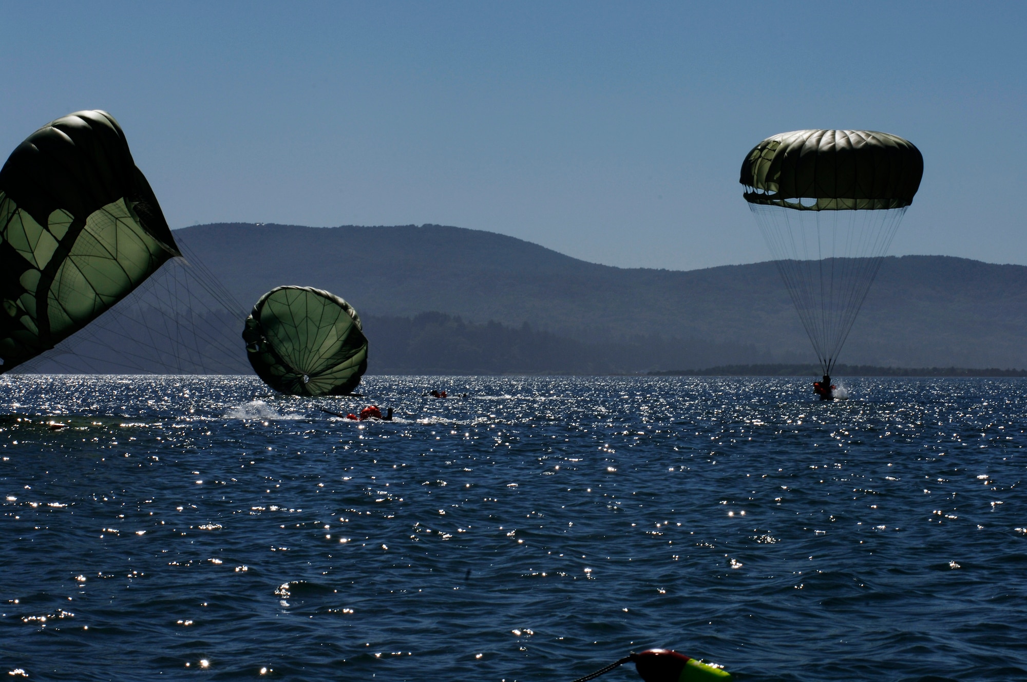 SERE instructors parachute into the ocean during the Coastal phase of training. (U.S. Air Force photo/Senior Airman Emerald Ralston)