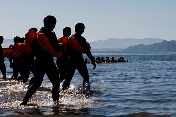 SERE students head into the water before sepending a few hours in a life raft, learning to survive in an ocean environment. (U.S. Air Force photo/Senior Airman Emerald Ralston)