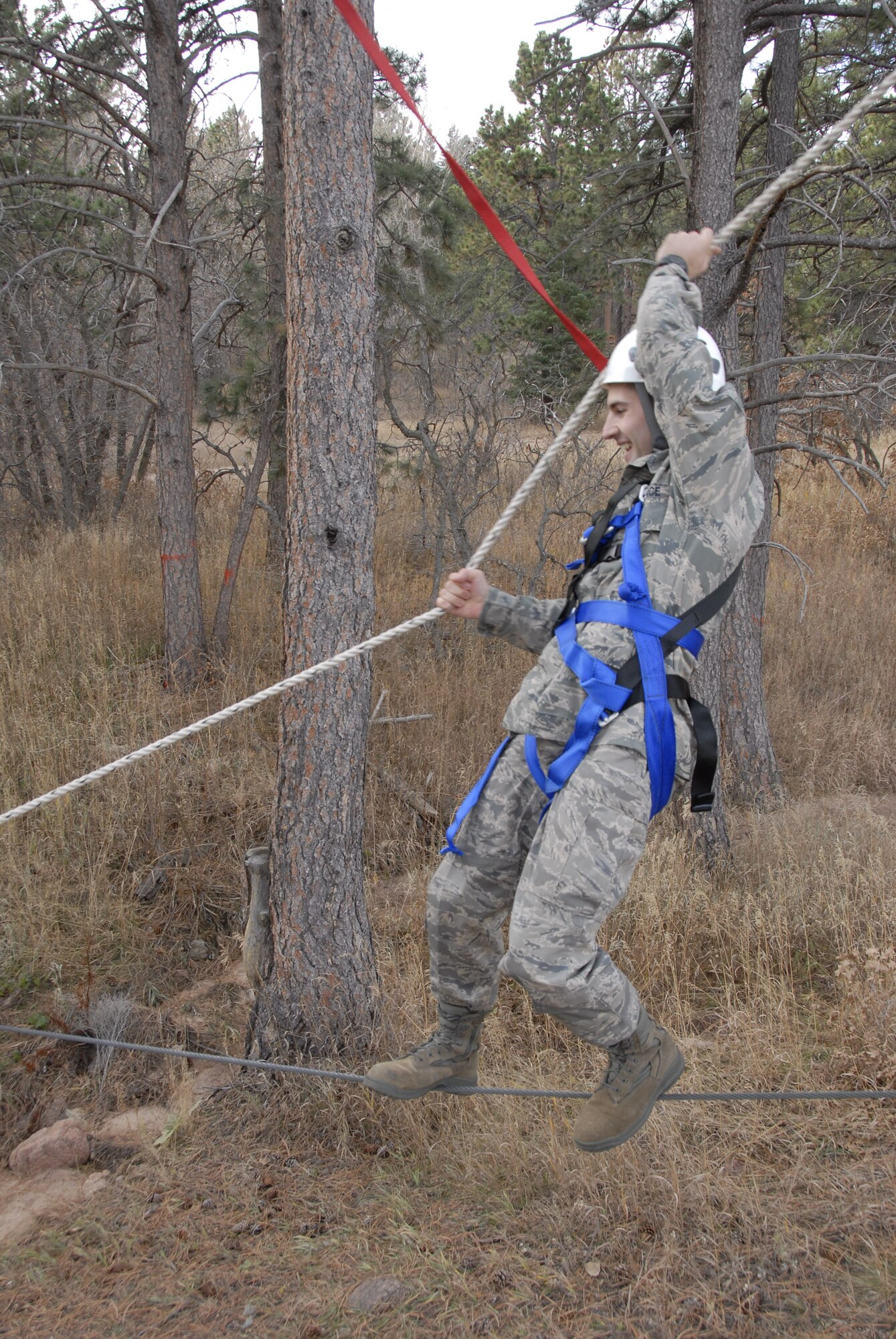 HANSCOM AIR FORCE BASE, Mass. - 1st Lieutenant Andrew Ramsey, operational contract manager with the 66th Contracting Squadron, traverses Bottleneck, an exercise designed to build teamwork, communication and problem-solving skills on the U.S. Air Force Academy's Adventure Based Learning Course in Colorado Springs, Colo. 28 Hanscom Airmen traveled to the Academy Nov. 5 through 8 to build camaraderie, observe cadet training, and experience Air Force Academy athletic events. (U.S. Air Force Photo by Capt. Geoff Buteau)