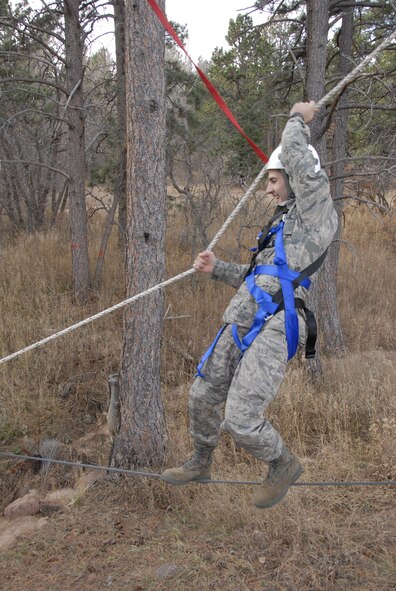 HANSCOM AIR FORCE BASE, Mass. - 1st Lieutenant Andrew Ramsey, operational contract manager with the 66th Contracting Squadron, traverses Bottleneck, an exercise designed to build teamwork, communication and problem-solving skills on the U.S. Air Force Academy's Adventure Based Learning Course in Colorado Springs, Colo. 28 Hanscom Airmen traveled to the Academy Nov. 5 through 8 to build camaraderie, observe cadet training, and experience Air Force Academy athletic events. (U.S. Air Force Photo by Capt. Geoff Buteau)