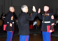 Chief Warrant Officer 3 Shane Rawlins, Marine Corps Det. commanding officer, administers the oath of enlistment to Gunnery Sgt. James Cowell (right) during the Marine Corps Birthday Ball Nov. 6. (U.S. Air Force photo/Alan Boedeker)