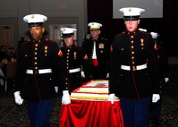 During the "Marching of the Cake," Marine escorts bring the birthday cake in as the Marines Hymn is played. The Marine Corps birthday cake-cutting ceremony is important to all Marines, as it is an annual renewal of each Marine's commitment to the Corps. (U.S. Air Force photo/Alan Boedeker)