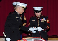 Chief Warrant Officer 3 Shane Rawlins, Marine Corps Det. commanding officer (left), passes the first piece of birthday cake to the guest of honor, Sgt. Eric Morante, a wounded warrior from Brooke Army Medical Center. Sergeant Morante was wounded by an Improvised Explosive Device while serving in Iraq in 2007. (U.S. Air Force photo/Alan Boedeker)