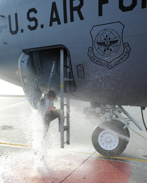 Col. John E. Michel, 319th Air Refueling Wing commander, is hosed down as he exits a KC-135 after his final flight as the 319th ARW commander Nov. 10 at Grand Forks Air Force Base. Colonel Michel will relinquish command of the 319th ARW to Col. Donald L. Shaffer during a change-of-command ceremony Nov. 13. (U.S. Air Force photo by Staff Sgt. Suellyn Nuckolls)