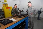 Staff Sgt. Ricardo Nunez briefs Col. David French, 542nd Combat Sustainment Wing vice commander, about the rebuild/refurbishment process for the M16A2. Sergeant Nunez is a combat arms instructor and M16A2 production manager with the 575th Combat Sustainment Squadron. (U.S. Air Force photo/Alan Boedeker)