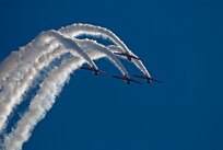 Four AT-6 Texan aircraft execute a precision maneuver during the Aeroshell Formation Demonstration at the Randolph Air Force Base Nov. 7. (U.S. Air Force photo by Wayne Cooper)