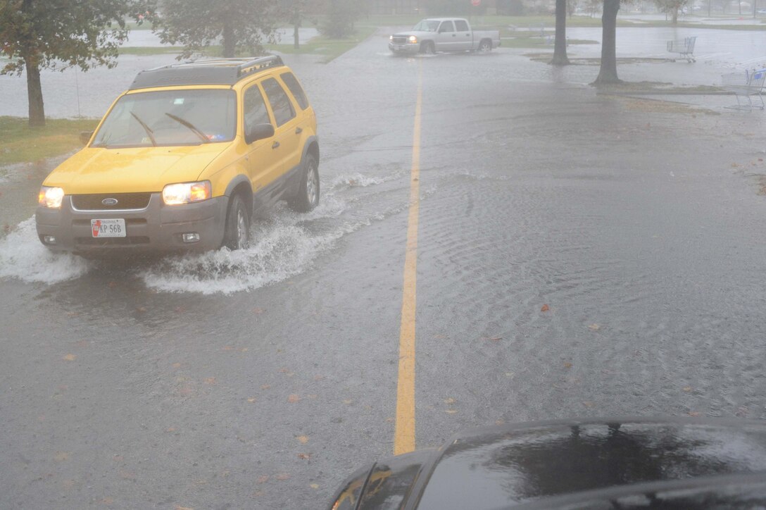 LANGLEY AIR FORCE BASE, Va. – Langley personnel drive through the flooded commissary parking lot Nov. 12.  A nor'easter dropped 8-10 inches of rain on Langley over the course of three days with wind gusts up to 55 mph.  (U.S. Air Force photo/Staff Sgt. Barry Loo)