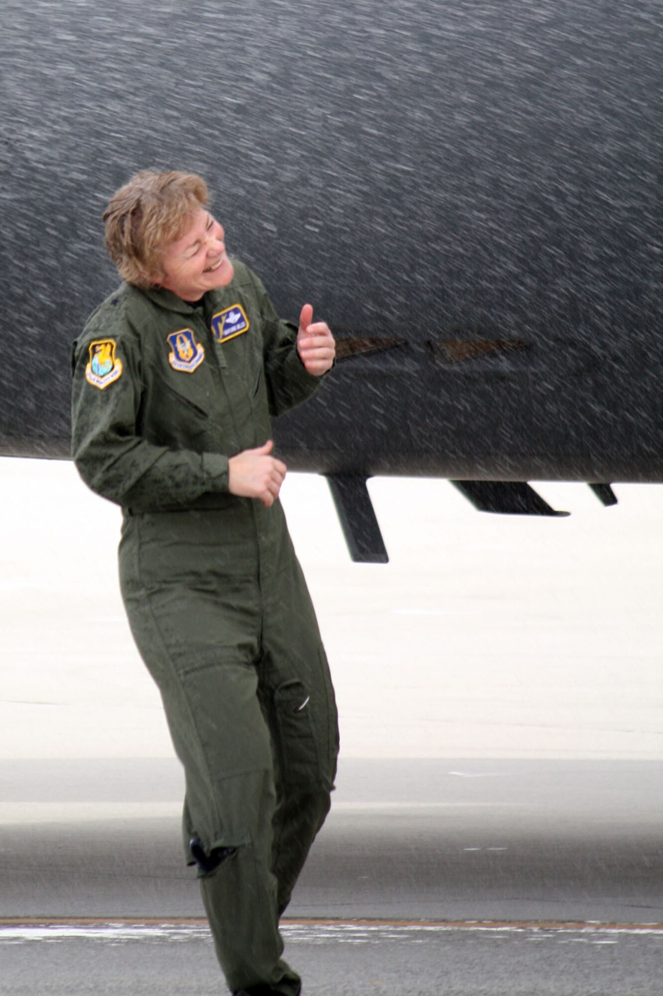 TRAVIS AIR FORCE BASE, Calif. -- Brig. Gen. Maryanne Miller, the 349th Air Mobility Wing commander, gets a thorough hosing down at the conclusion of her fini flight here. Gen. Miller conducted her last flight was the wing commander on the Spirit of the Golden Bear, a C-17 Globemaster III assigned at Travis. Gen. Miller will be moving on to the Pentagon for her new assignment. (U.S. Air Force photo/Master Sgt. Robert Wade)