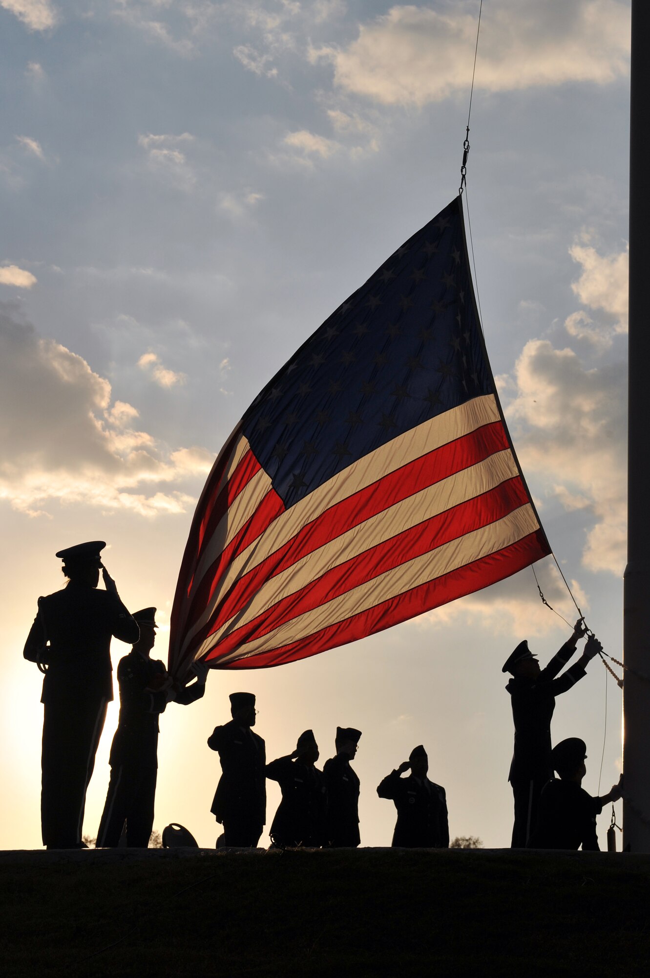 Members of the Little Rock Air Force Base Honor Guard lower the flag during a Veterans Day retreat Nov. 10 at Heritage Park. On June 1, 1954, Congress voted to change Nov. 11 from “Armistice Day” to “Veterans Day” to honor American Veterans of all wars.  (U.S. Air Force photo by Staff Sgt. Chris Willis)