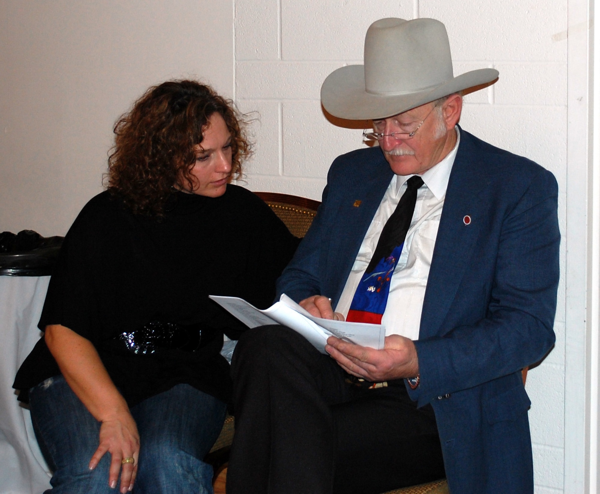 Malstrom Spouses' Club president Cheree Zeigler and auctioneer Fred Burow go over the items that will be up for bid during the 21st annual Mercantile Auction Nov. 7 at the Grizzly Bend Club. The event raised more than $13,000 that will be used for educational scholarships and other contributions to charity. (U.S. Air Force photo/Valerie Mullett)