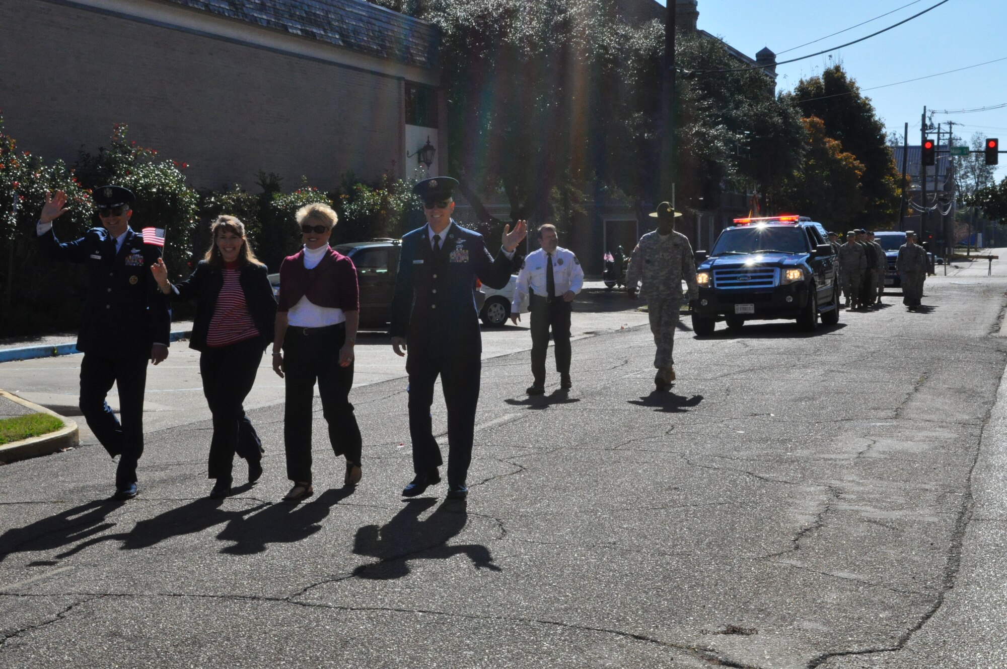 Col. Roger Watkins, 14th FTW commander, his wife Leslie Watkins, Chief Master Sgt. Richard Brackett, 14th FTW command chief master sergeant, and his wife Debbie Brackett, march in the Veteran’s Day Parade Nov. 7. (U.S. Air Force photo/Sonic Johnson)