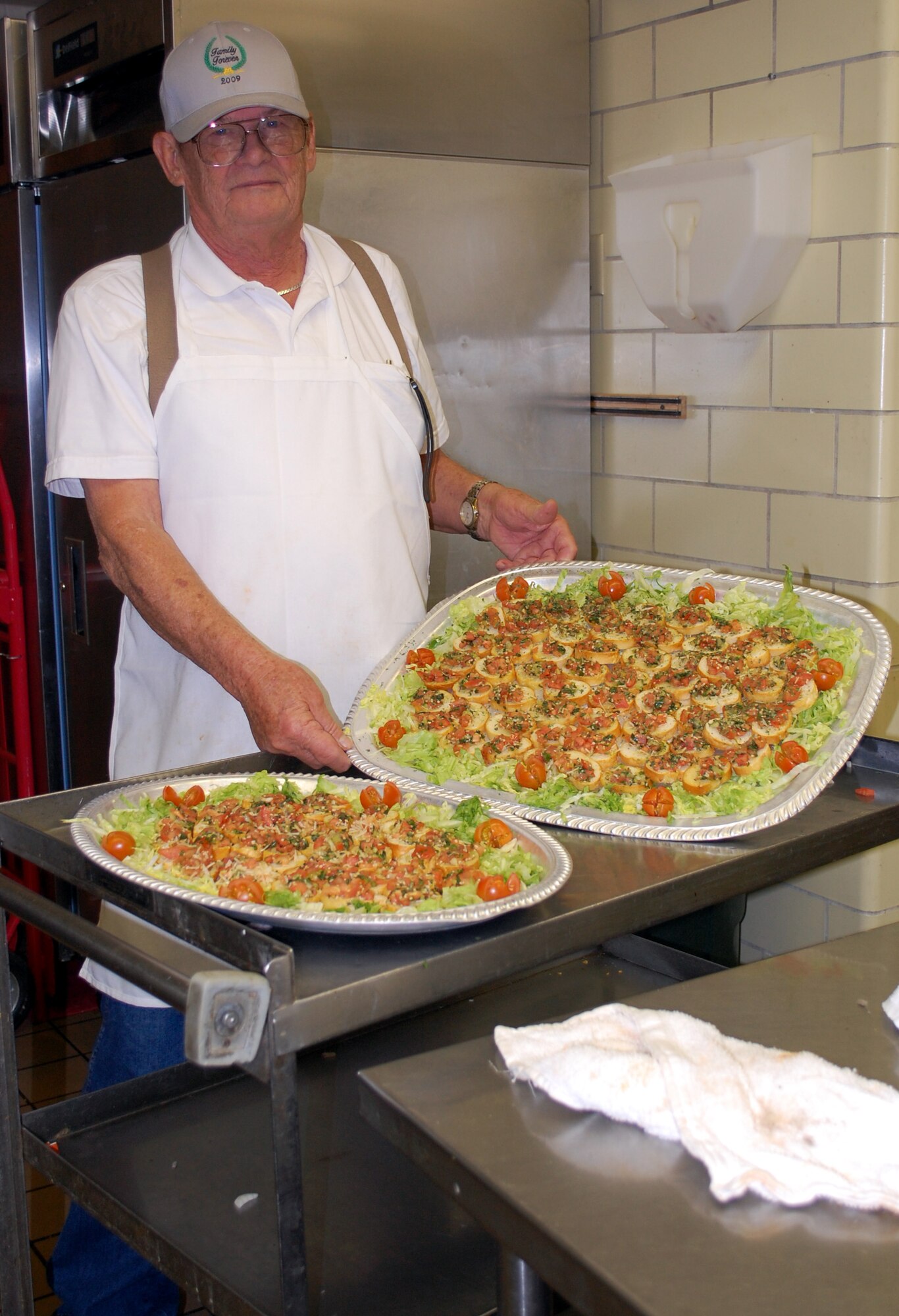 Longtime Grizzly Bend Club Chef Warren Davis shows off a tray of his tomato crostini's which were a hit among Mercantile Auction attendees Nov. 7 (U.S. Air Force photo/Valerie Mullett)