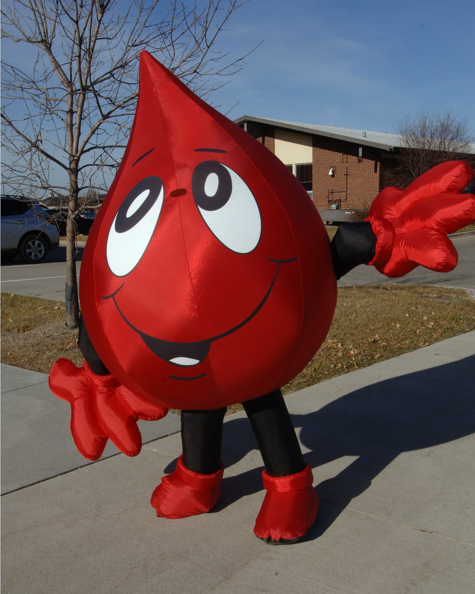 An Airman dresses up like a drop of blood Nov. 10 on Grand Forks Air Force Base to direct people to a blood drive held at the base chapel. During the blood drive, 50 pints of blood were collected. Each pint can save up to four lives. (U.S. Air Force photo by Senior Airman R. Michael Longoria)