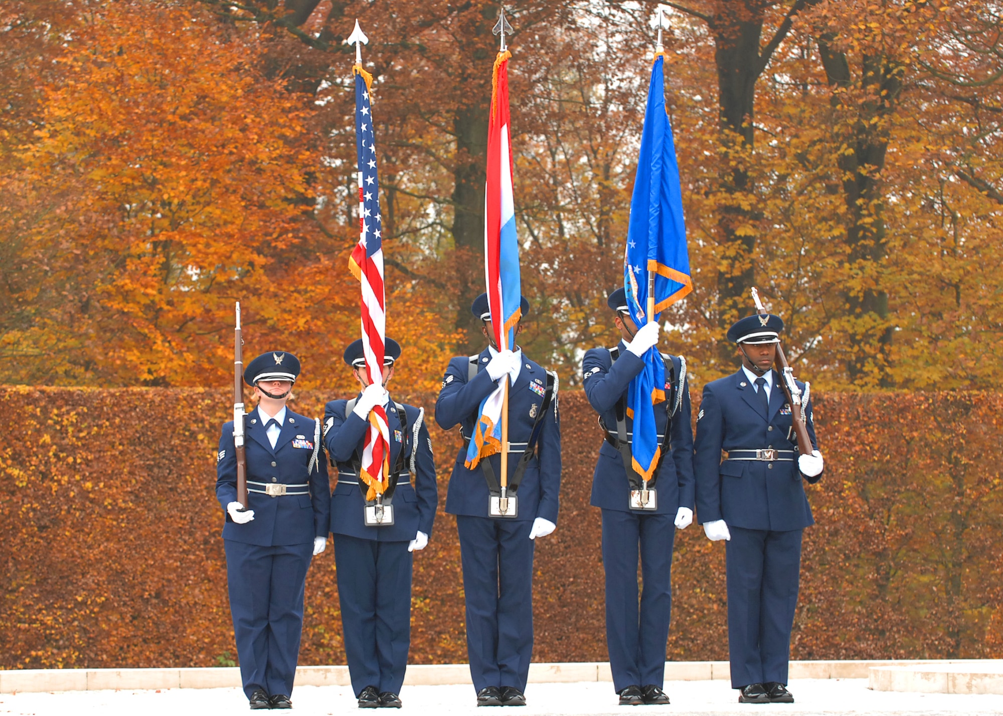 SPANGDAHLEM AIR BASE, Germany -- The 702nd Munitions Support Squadron Color Guard stands at attention before posting the colors for the annual Veterans Day ceremony at the Luxembourg American Cemetery and Memorial in Luxembourg City Nov. 11.  The 50.5 acre cemetery, which is one of 14 American cemeteries established overseas after World War II, contains the remains of more than 5,000 American servicemembers who died fighting in World War II. (U.S. Air Force photo/Airman 1st Class Nick Wilson)