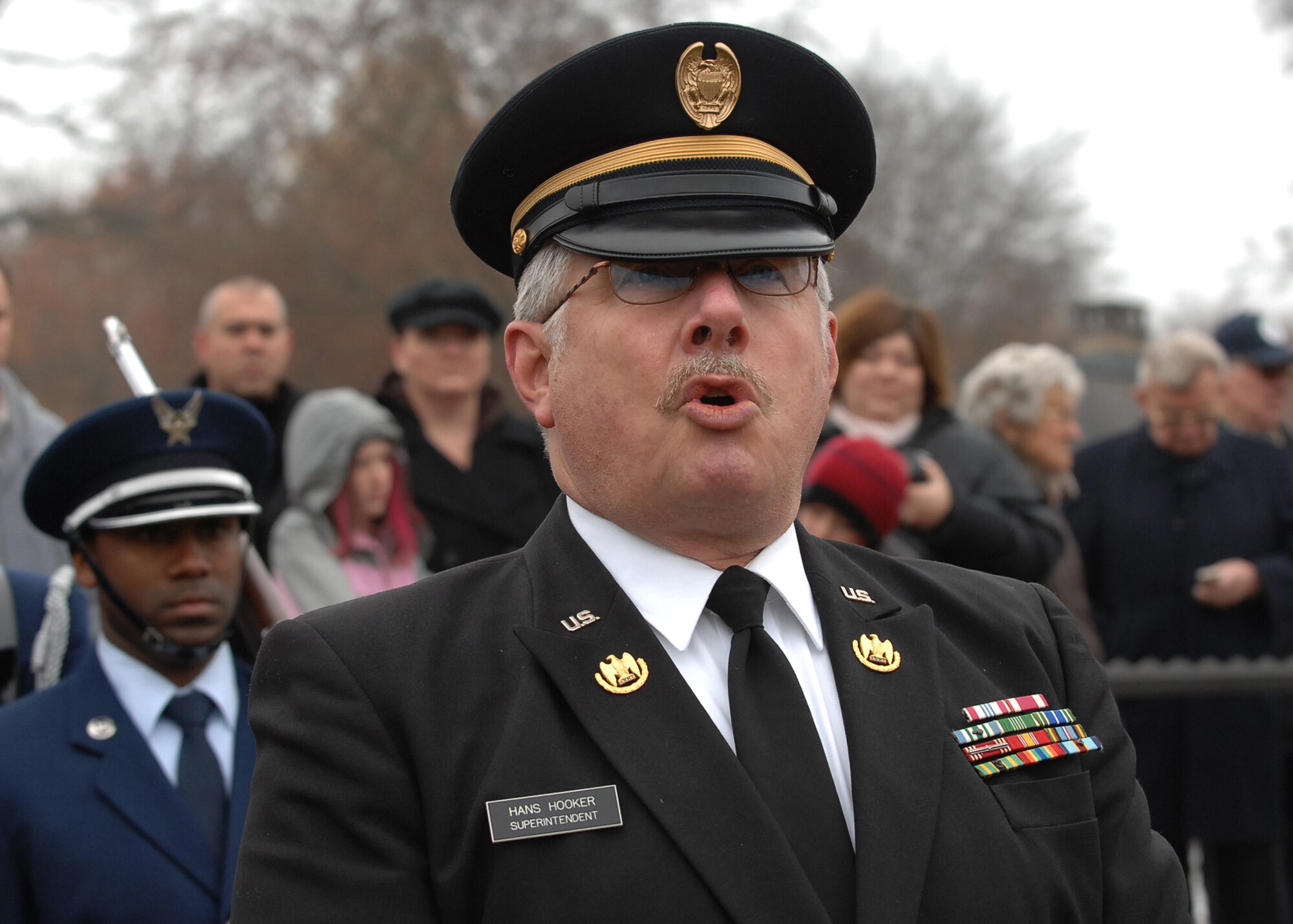 SPANGDAHLEM AIR BASE, Germany -- Hans Hooker, superintendant of the Luxembourg American Cemetery and Memorial, speaks in front of the grave of Gen. George S. Patton Jr., Third Army commander during World War II, during the annual Veterans Day ceremony at the Luxembourg American Cemetery and Memorial in Luxembourg City Nov. 11. More than 5,000 American servicemembers from World War II now rest at the 50.5 acre cemetery, which is one of 14 American cemeteries established overseas after World War II. (U.S. Air Force photo/Airman 1st Class Nick Wilson)