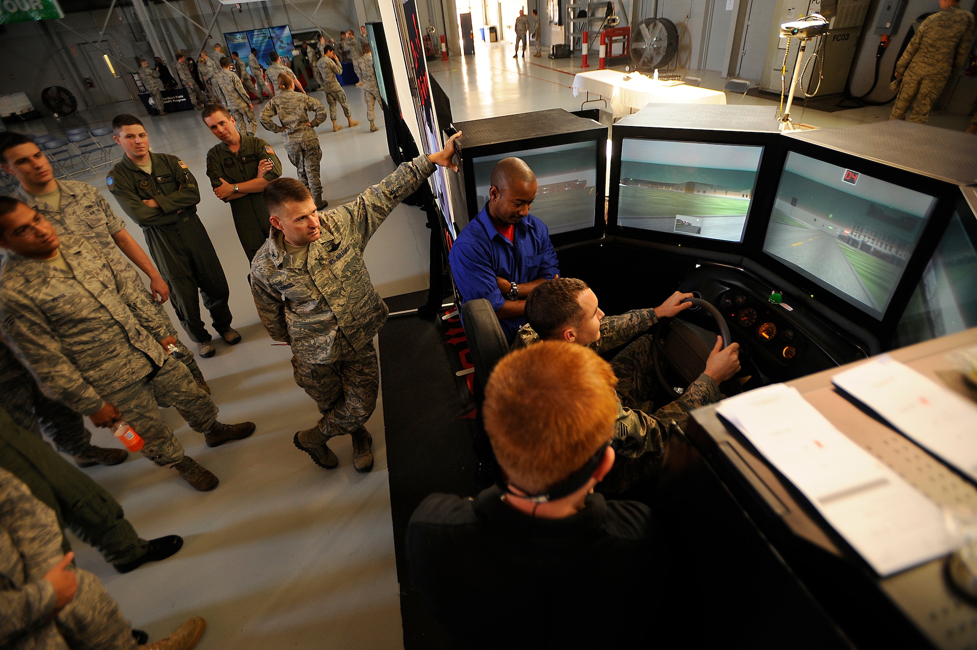 U.S. Air Force Col. Greg Lengyel, 1st Special Operations Wing commander, and Airmen assigned to the 1st Special Operations Wing watch a demonstration of a drunk driving simulator during the Save a Life Tour at Hurlburt Field, Fla., Nov. 05, 2009. (U.S. Air Force photo by Senior Airman Jason Epley)