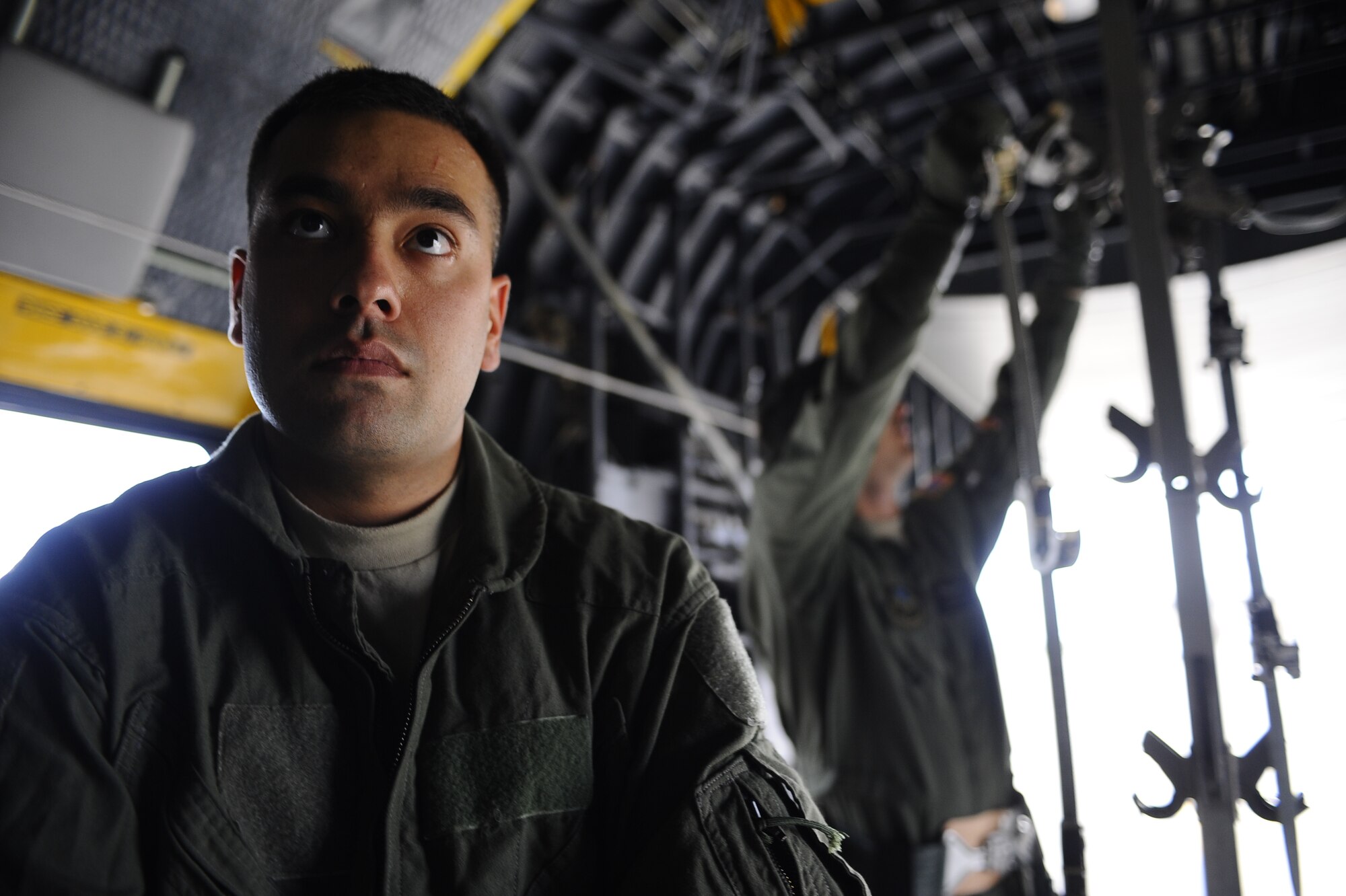 U. S. Air Force Senior Airman Bryon Brightman (front), 58th Rescue Squadron, Nellis Air Force Base, Nev., assists U.S. Air Force Capt. Robert Clontz II (back), 1st Special Operations Support Squadron, by looking for additional slots to hang litter stanchions during set up for a casualty evacuation training mission, Oct. 27, 2009, Hurlburt Field, Fla. (U.S. Air Force photo by Senior Airman Julianne Showalter/Released)