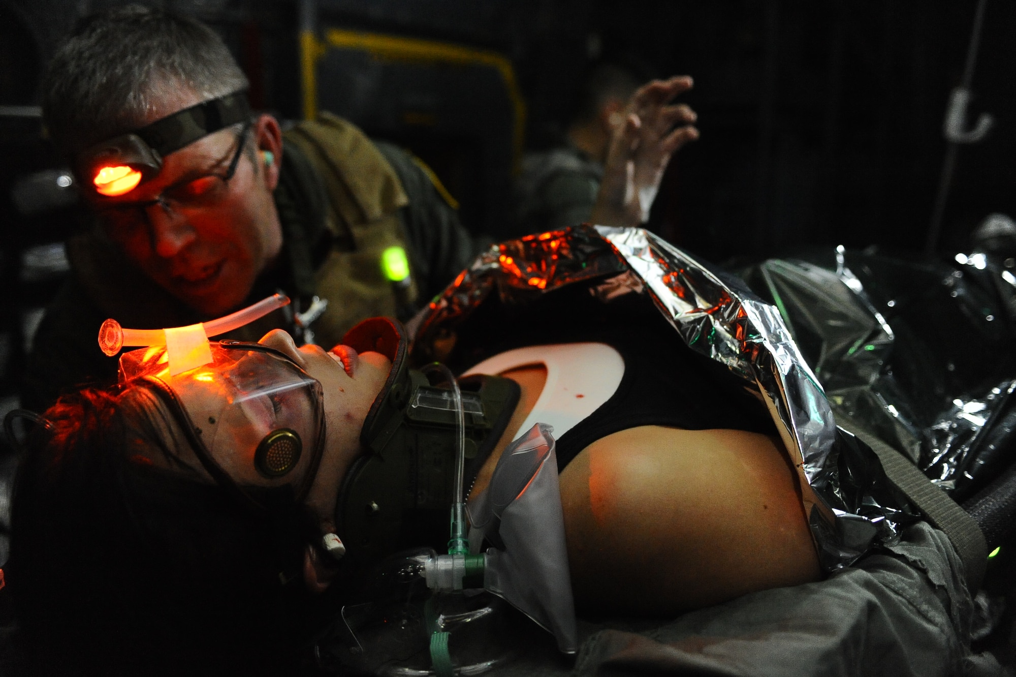 U. S. Air Force Lt. Col David Luther, 352nd Special Operations Support Squadron, Royal Air Force Mildenhall, England, treats simulated patient Airman 1st Class Nichole Dunnam, 1st Special Operations Component Maintenance Squadron,  for various wounds during a casualty evacuation training mission, Oct. 27, 2009, Hurlburt Field, Fla. (U.S. Air Force photo by Senior Airman Julianne Showalter/Released)