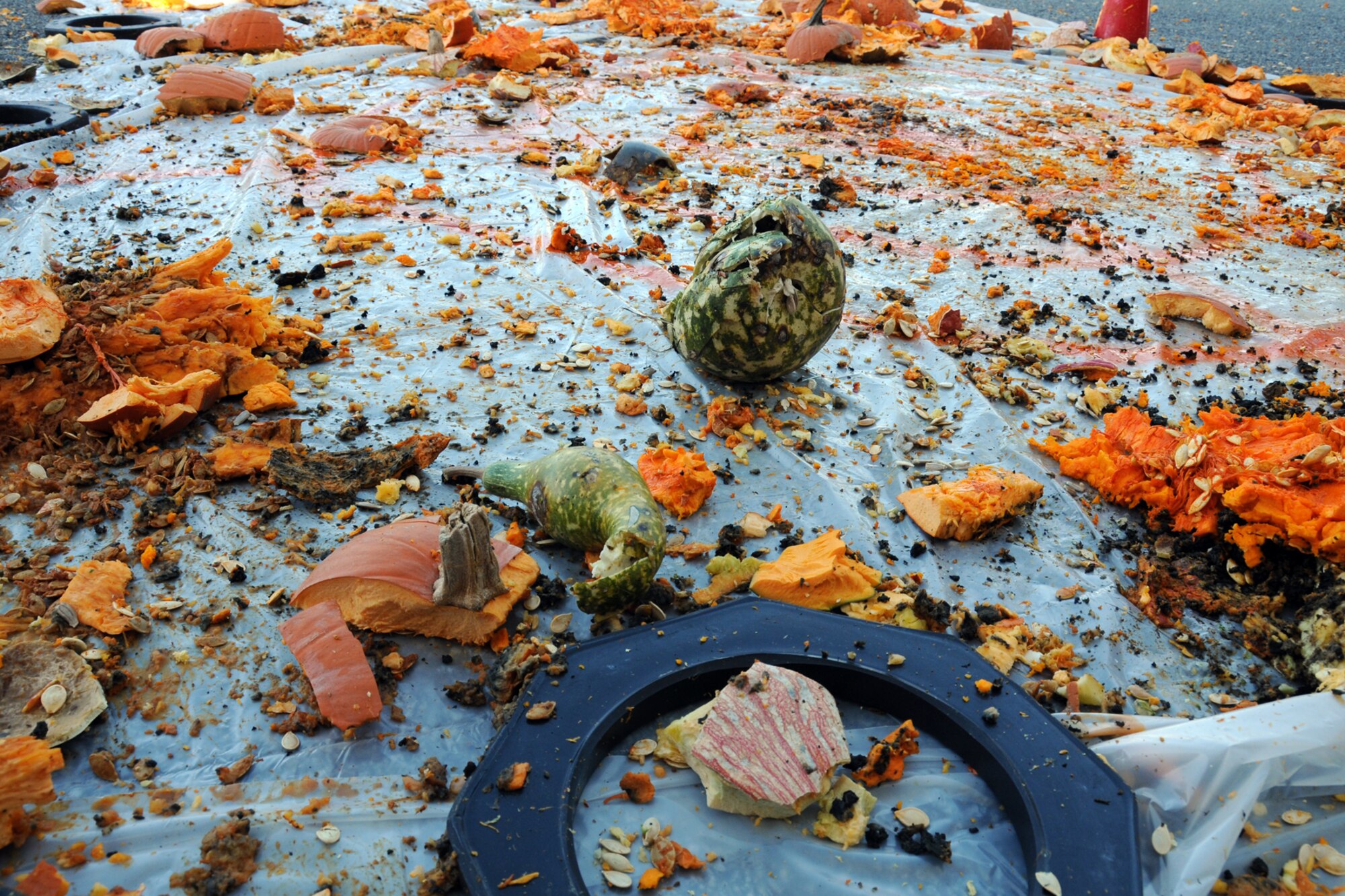 EGLIN AIR FORCE BASE, Fla. – The remains of obliterated pumpkins lay strewn across a tarp after a Pumpkin Smash competition Nov. 12. Participants tossed pumpkins from the top of a six-story building, aiming at a target on the ground. The event was hosted by the 53rd Wing as a fundraiser for their upcoming Children’s Christmas Party. (U.S. Air Force/ Airman 1st Class Anthony Jennings)