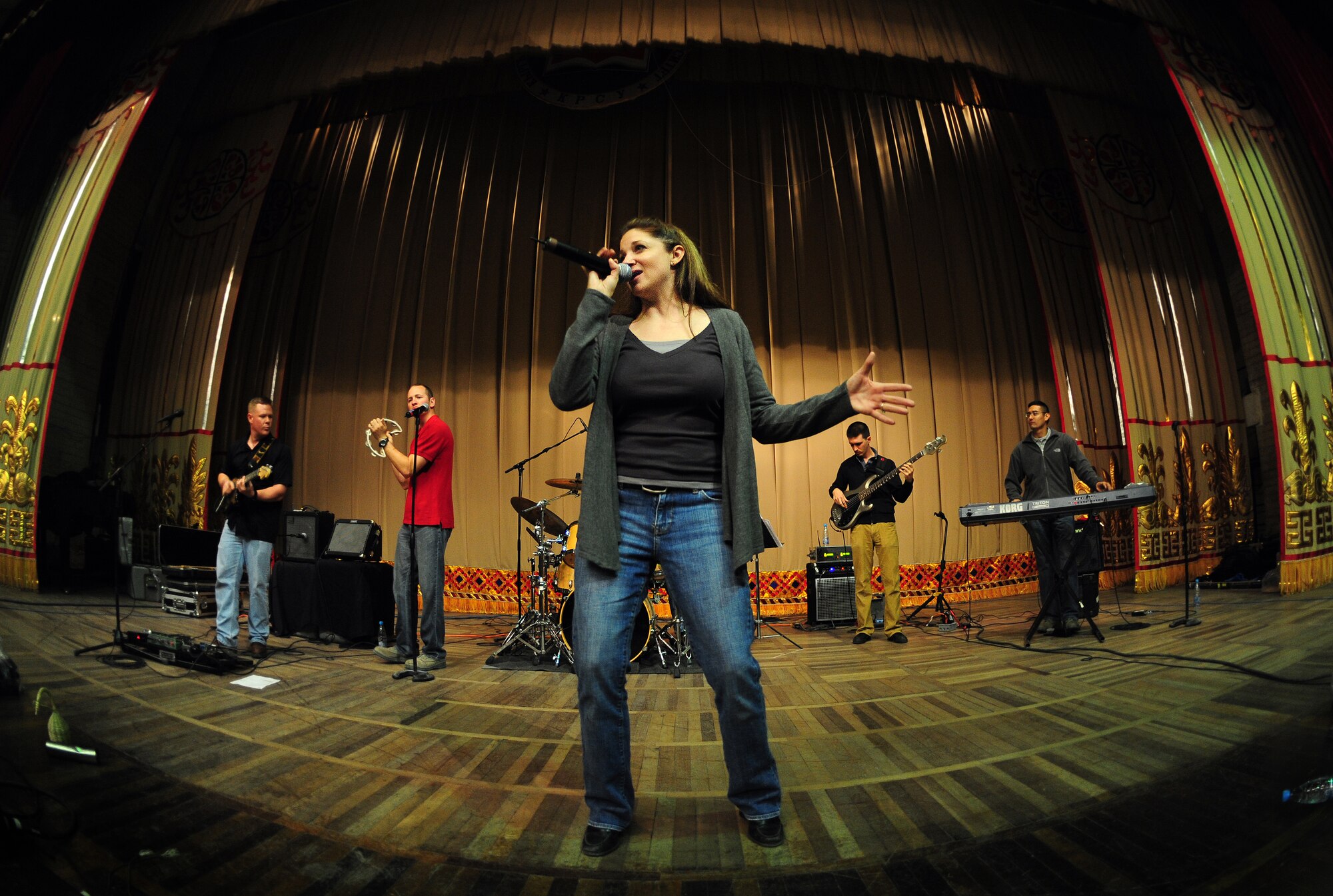 BISKEK, Kyrgyzstan -- Tech. Sgt. Christin Foley, U.S. Air Forces Central Sirocco Band vocalist takes center stage during a performance at the Kyrgyz-Russian Slavic University, Nov. 13, 2009. The Sirocco band is from a base in Southwest Asia and are deployed from Lackland Air Force Base, Texas. (U.S. Air Force photo/Senior Airman Steele C. G. Britton)