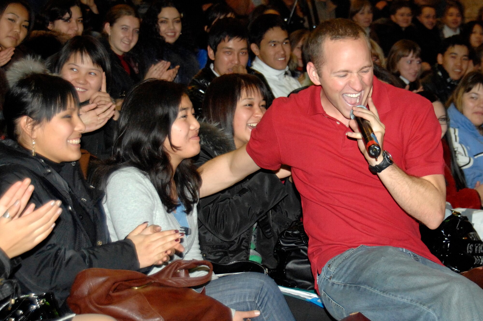 BISHKEK, Kyrgyzstan -- Airman 1st Class Clayton Lee, U.S. Air Forces Central Sirocco Band vocalist, entertains the crowd during a performance at the Kyrgyz-Russian Slavic University, Nov. 13, 2009. Airman Lee and the Sirocco Band members are stationed at a base in Southwest Asia and are deployed from Lackland Air Force, Texas. (U.S. Air Force photo/Senior Master Sgt. Andrew E. Lynch)