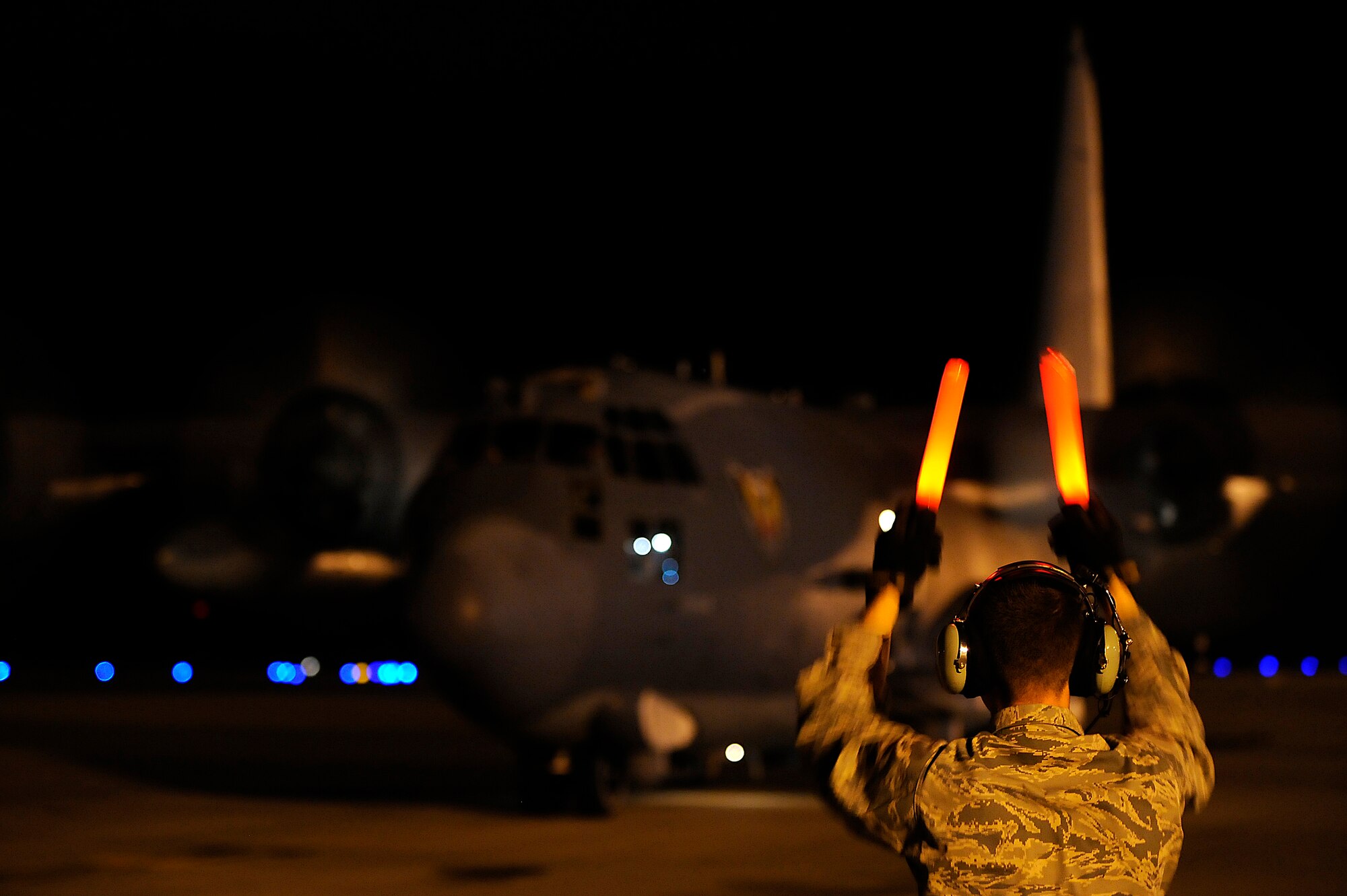 U.S. Air Force Senior Airman James Swiderski, a crew chief assigned to the 1st Special Operations Maintenance Squadron, marshals an AC-130U Spooky Gunship from the 4th Special Operations Squadron at Hurlburt Field, Fla., Nov. 10. Hurlburt Field planes returned after being evacuated as Tropical Storm Ida approached the Gulf Coast region.  (U.S. Air Force photo by Senior Airman Jason Epley)