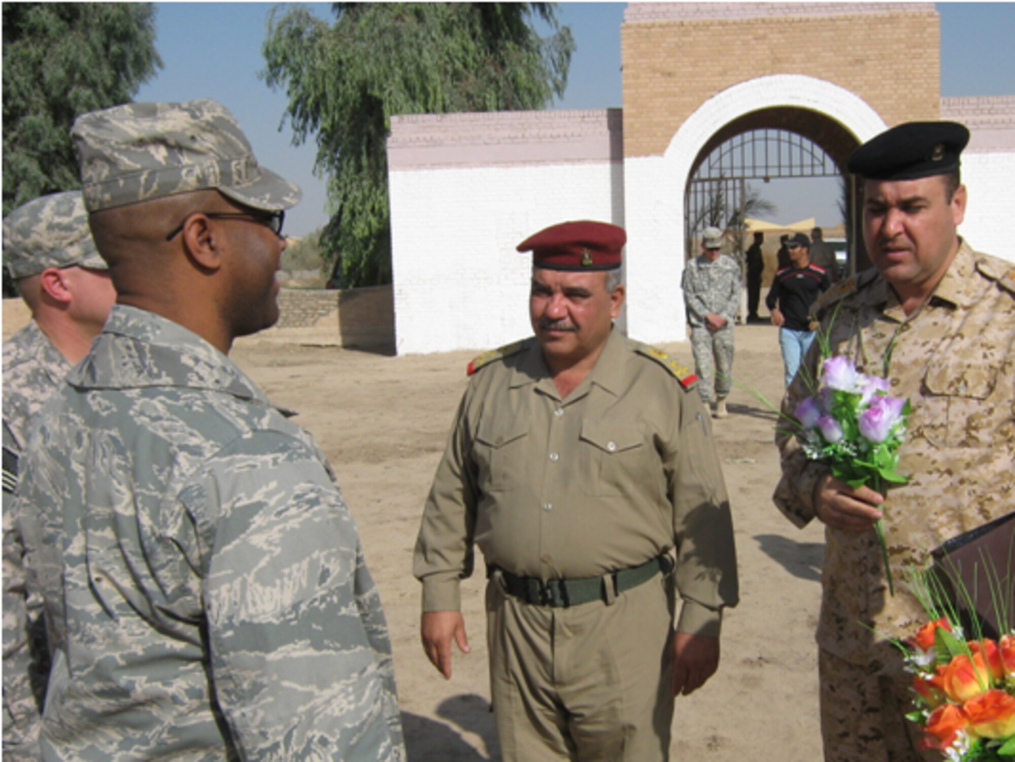 Habbaniya, Iraq-- Chaplain (Capt.) Shawn Menchion, 732nd Air Expeditionary Group chaplain,  presides over a remembrance ceremony Nov. 11. This year, the Royal Air Force Habbaniya Society, in coordination with 732 ELRS Logistics Military Advisory Team, held the Remembrance Ceremony at the RAF Commonwealth War Graves Cemetery, Habbaniya, Iraq.  More than 55 coalition and Iraqi Army personnel attended. In Britain, the Act of Remembrance is either on Armistice Day at the 11th hour of the 11th day of the 11th month (when the WW1 Armistice was signed) or at 11a.m. on the Remembrance Sunday closest to it. The first time this ceremony took place in Iraq was after the Royal Air Force was forced to leave in 1959. Chaplain Menchion is deployed from Eglin AFB. (courtesy photo)