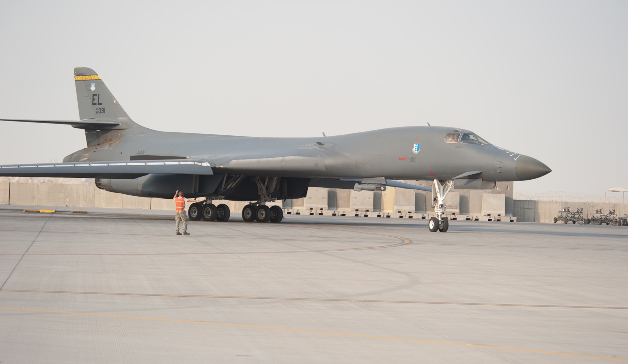 Staff Sgt. Daniel Gordon, 37th Aircraft Maintenance Unit, marshals a B1-B Lancer as it taxis on a Southwest Asia runway in preparation for take-off on a combat mission in the U.S. Central Command area of responsibility, Nov. 11, 2009. Carrying the largest payload of both guided and unguided weapons in the Air Force inventory, the multi-mission B-1 is the backbone of America's long-range bomber force. The B-1 is deployed from Ellsworth Air Force Base, S.D., in support of operations Iraqi Freedom and Enduring Freedom. (U.S. Air Force photo/Staff Sgt. Robert Barney)