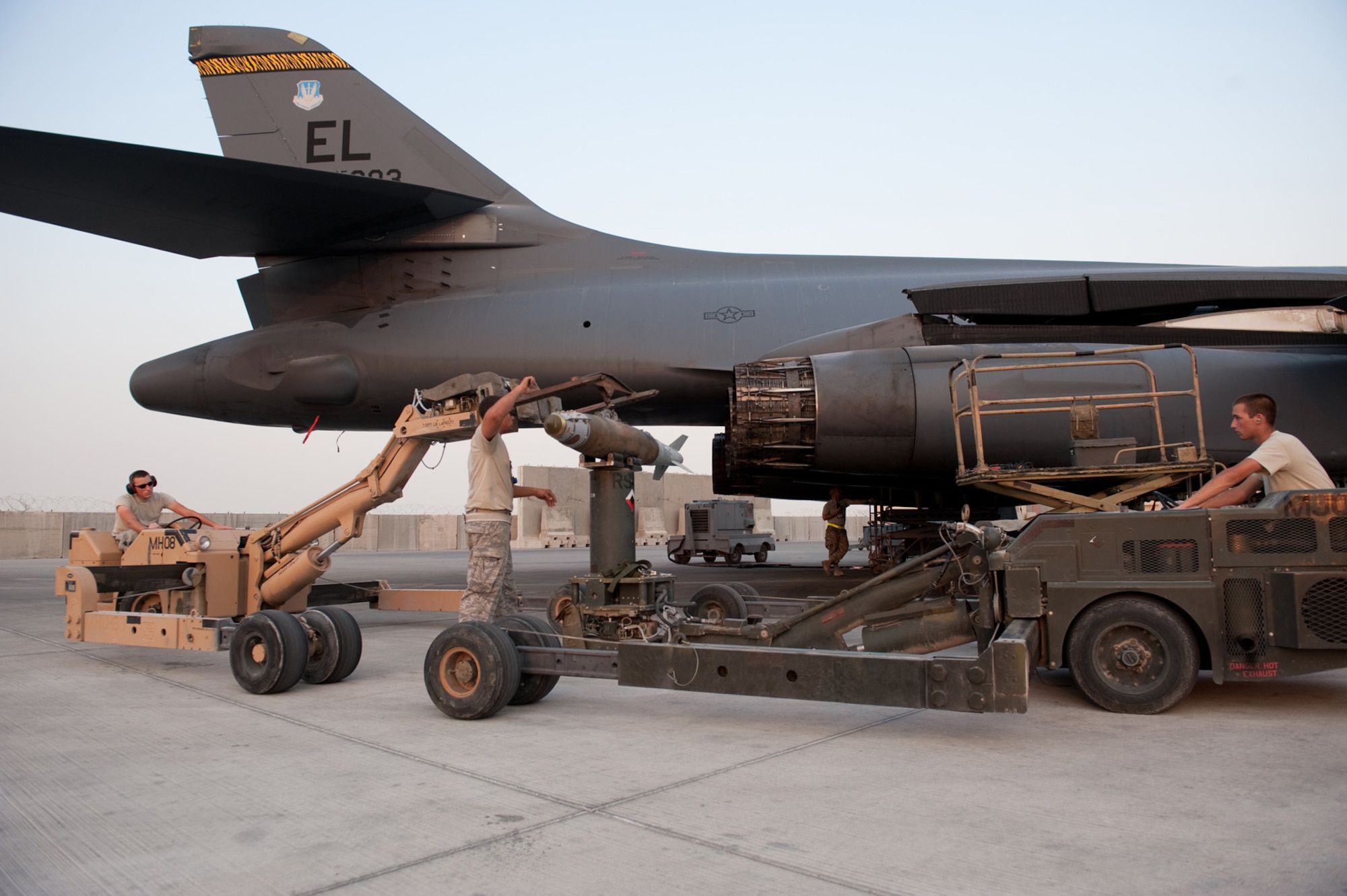 Left to right, Airmen 1st Class Michael Huber, Phillip Rhinehart, and Matthew Beard load GBU-38s onto a B-1B Lancer, Nov. 11, 2009, in Southwest Asia. Carrying the largest payload of both guided and unguided weapons in the Air Force inventory, the multi-mission B-1 is the backbone of America's long-range bomber force. The Airmen are deployed with the aircraft from Ellsworth Air Force Base, S.D., in support of operations Iraqi Freedom and Enduring Freedom. (U.S. Air Force photo/Staff Sgt. Robert Barney)