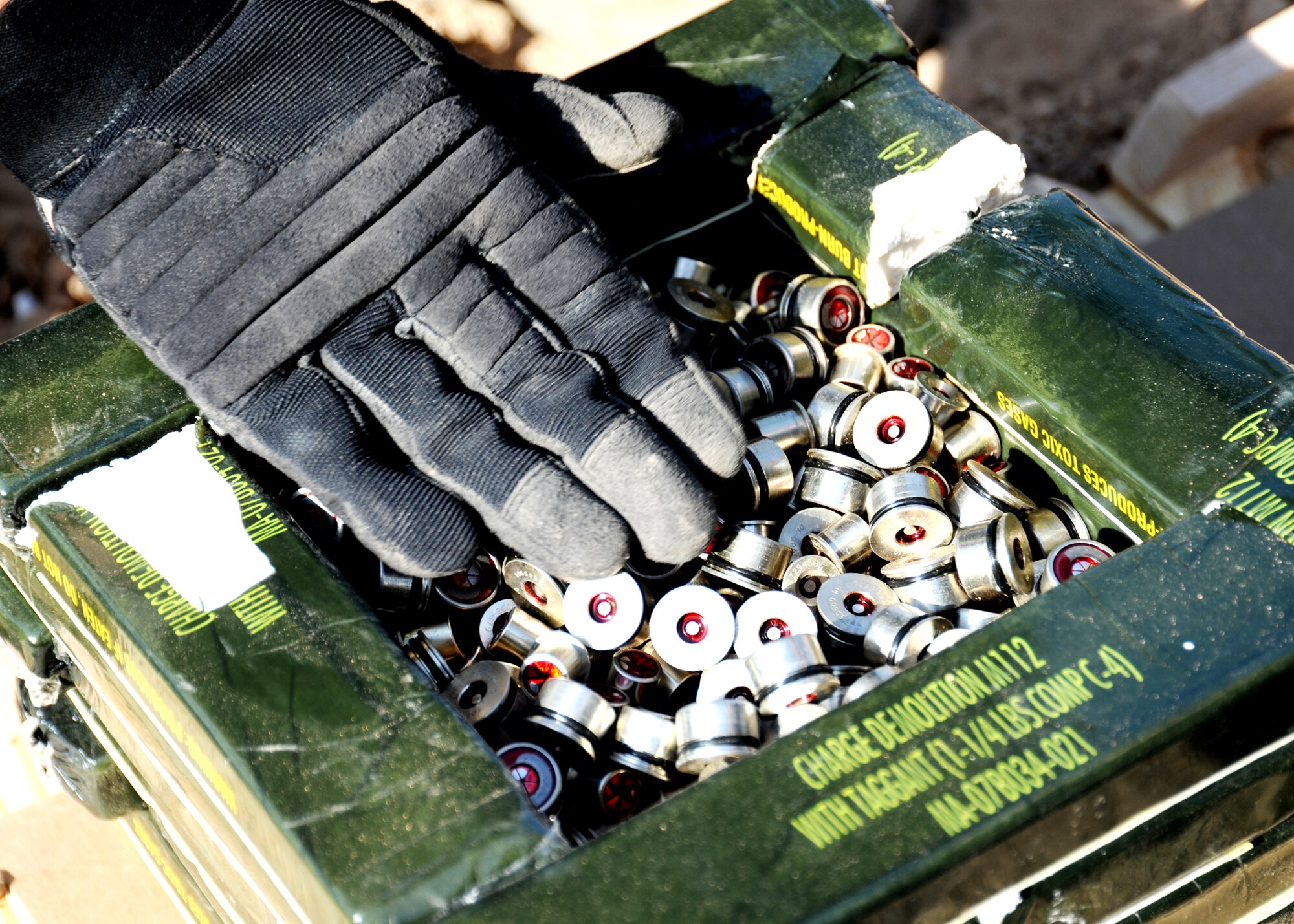 JOINT BASE BALAD, Iraq -- Tech. Sgt. Chip Fudala, 332nd Expeditionary Civil Engineer Squadron explosive ordnance disposal team leader, packs down primers between C4 explosives prior to a controlled detonation Nov. 11, 2009. The EOD's primary mission is to dispose of unused and unexploded ordnance. (U.S. Air Force photo/Senior Airman Christopher Hubenthal)