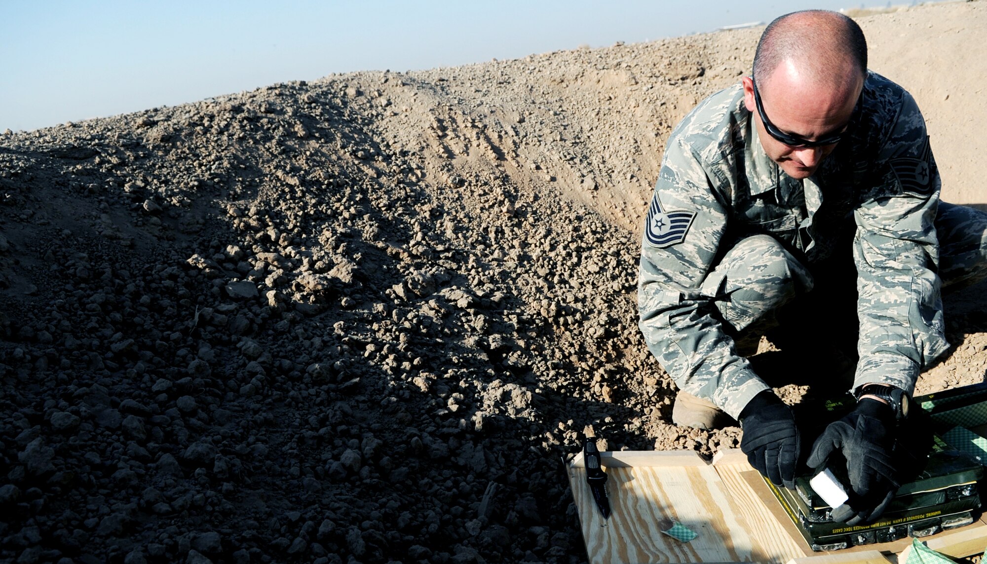 JOINT BASE BALAD, Iraq -- Tech. Sgt. Chip Fudala, 332nd Expeditionary Civil Engineer Squadron explosive ordnance disposal team leader, packs C4 explosives prior to a controlled detonation Nov. 11, 2009. The EOD's primary mission is to respond to indirect fire attacks on JBB and dispose of unexploded ordnance. (U.S. Air Force photo/Senior Airman Christopher Hubenthal)