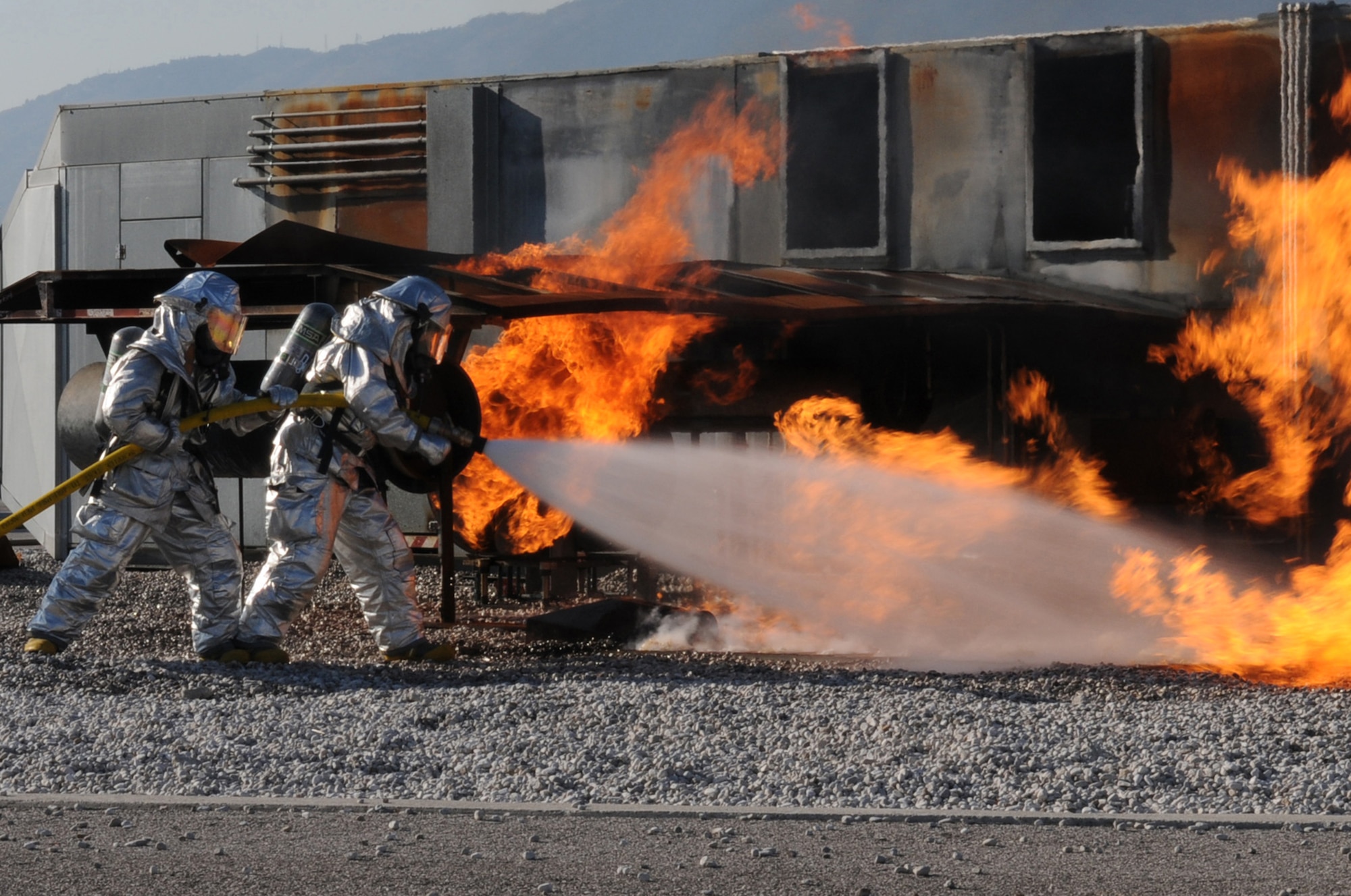 Firefighters assigned to the 31st Civil Engineer Squadron extinguish flames during a simulated aircraft accident during a training exercise Nov. 11, 2009 at Aviano Air Base, Italy.  The 31st CES fire department conducted a three-day training course with four Italian Air Force firefighters from Decimomannu Air Base, Sardinia, Italy.  The course consisted of hydrazine, F-16 aircraft emergency response procedures and pilot egress, structural fire fighting tactics and strategy.

(U.S. Air Force photo/ Senior Airman Nadine Y. Barclay)