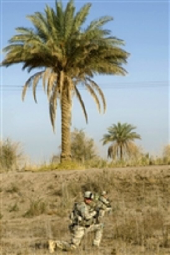 U.S. Army soldiers attached to Bravo Company, 5th Battalion, 20th Infantry Regiment, 3rd Stryker Brigade Combat Team, 2nd Infantry Division kneel while conducting a patrol in Naquib, Iraq, on Nov. 8, 2009.  The soldiers are patrolling the area to search open fields for signs of suspected weapons caches.  